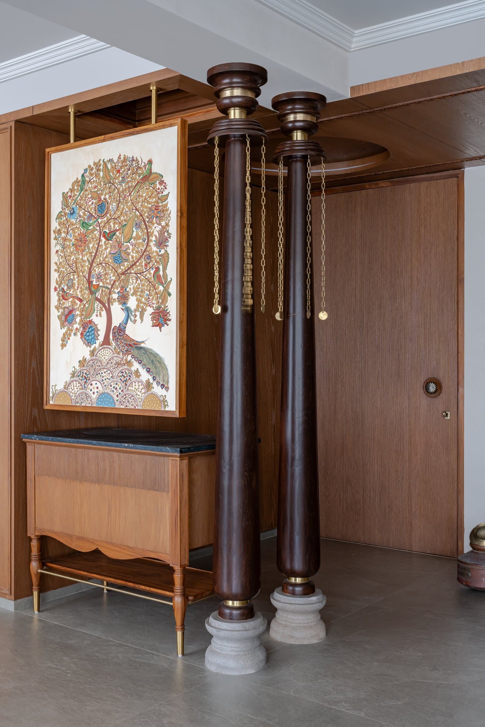 Wing B's foyer columns and tree-of-life painting, a variation on the shared entrance grammar