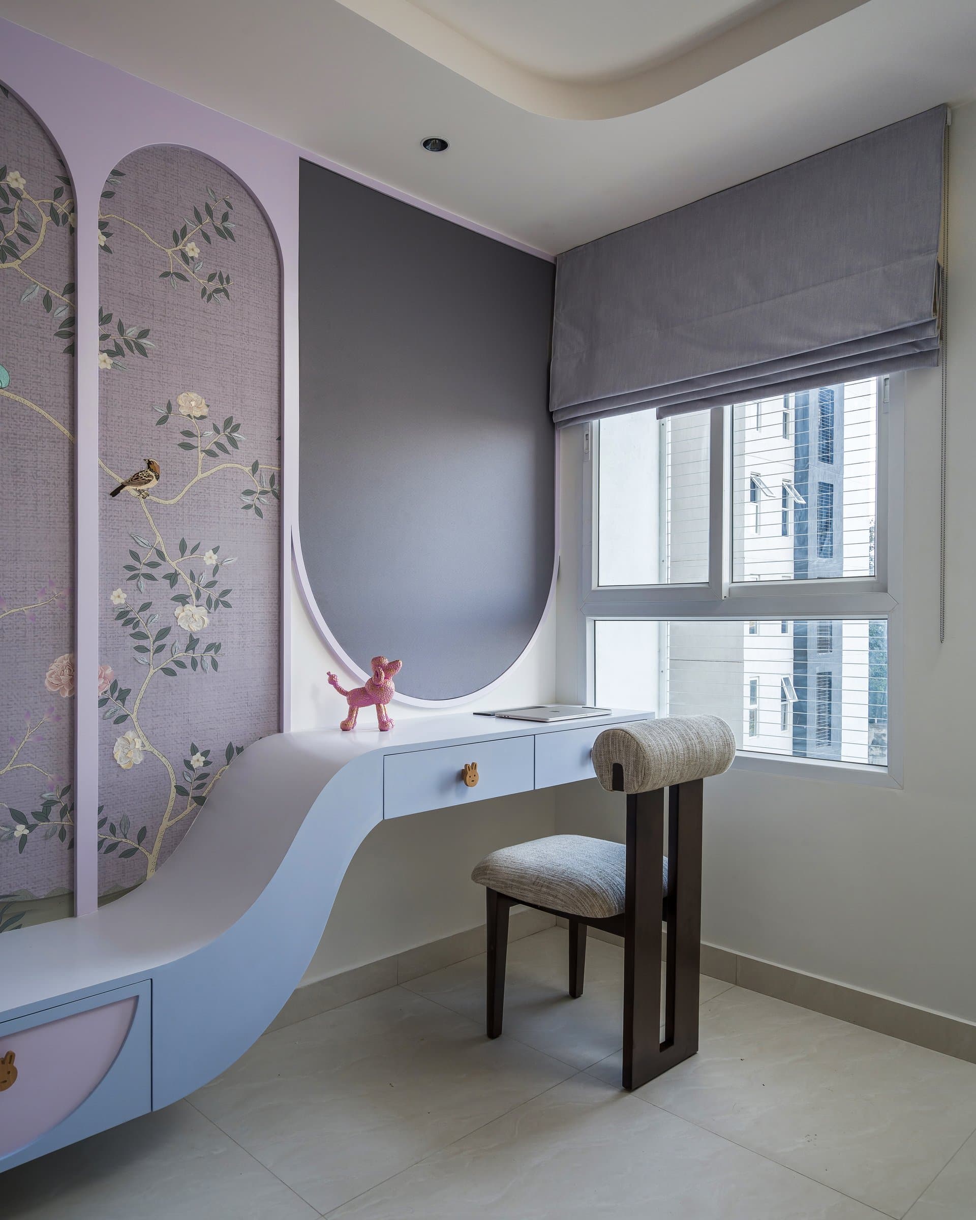 The study corner, where a single unbroken curve connects storage to desk surface