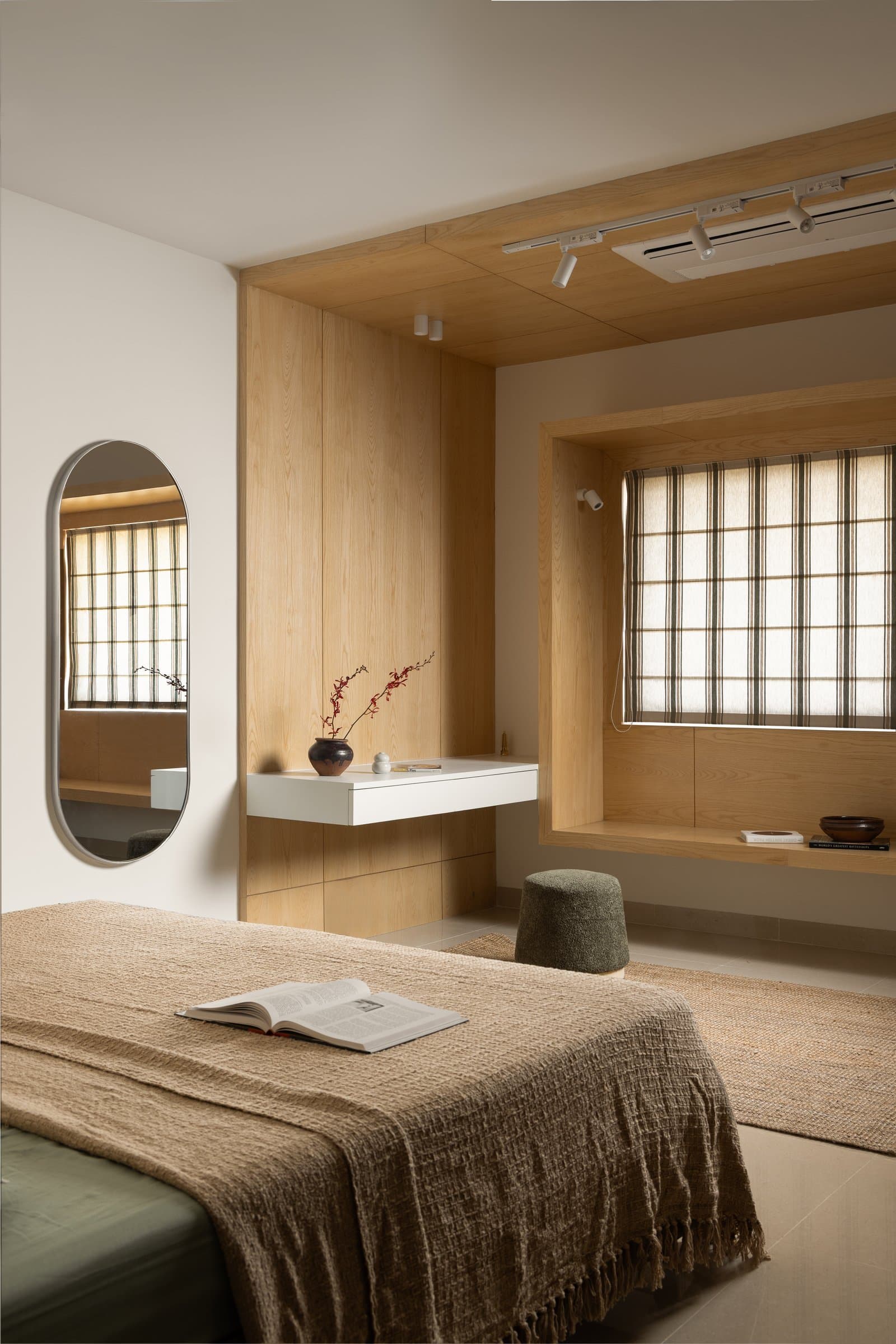 The daughter's bedroom, organised around a custom light-oak bay window that doubles as a study