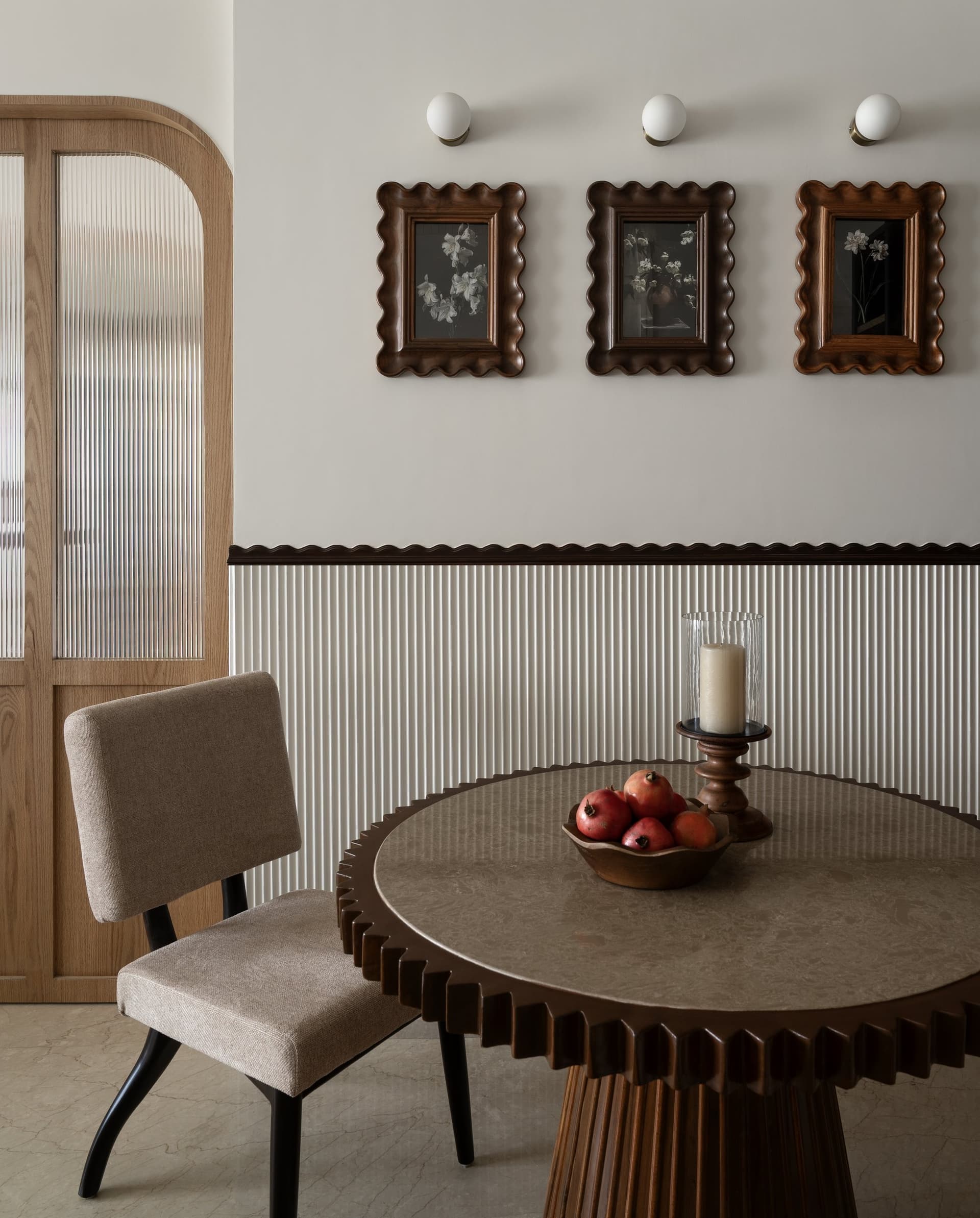 The dining table behaves like a piece of sculpture, its sunburst-fluted base reading as its plinth