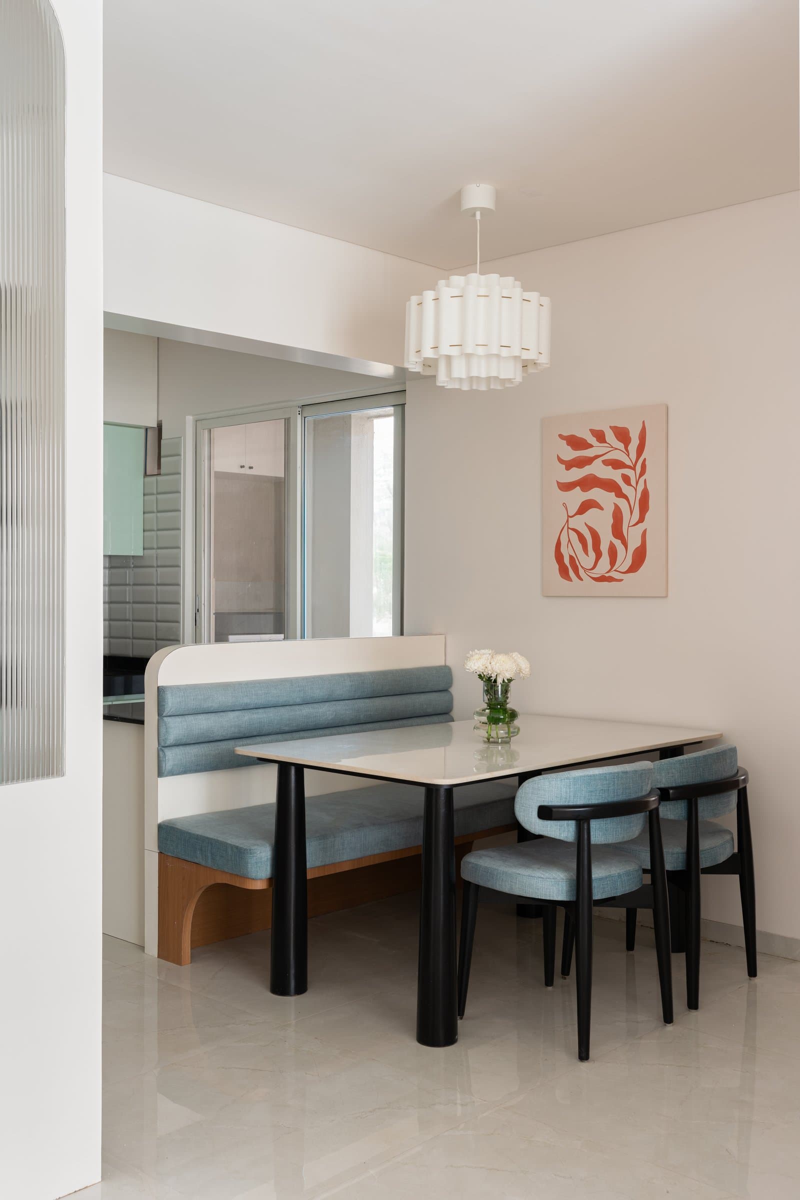 The dining nook: a built-in banquette and cylindrical pendant create intimacy within the open plan