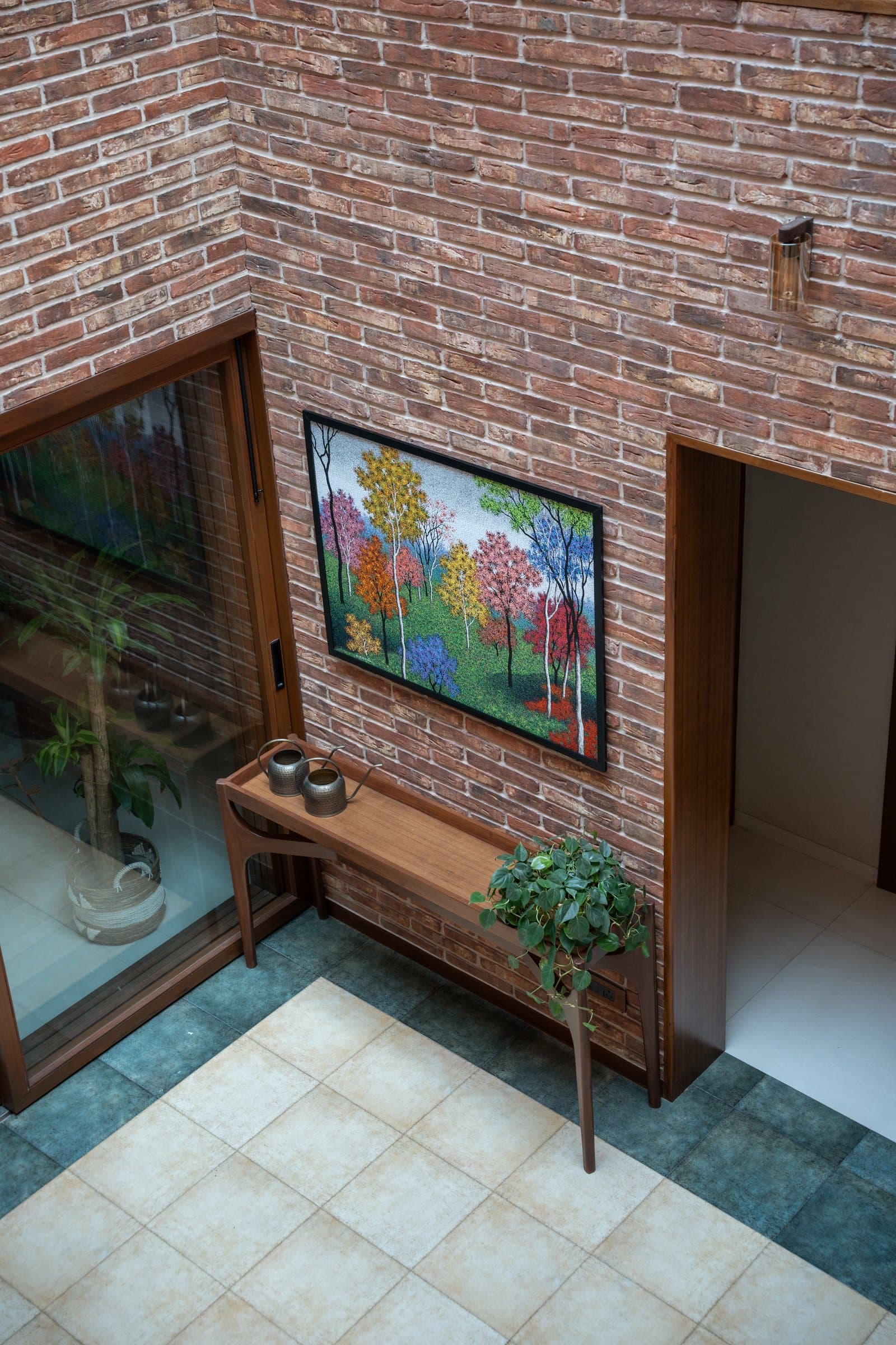 The entry volume seen from above, where the double-height brick atrium first reveals its vertical ambition