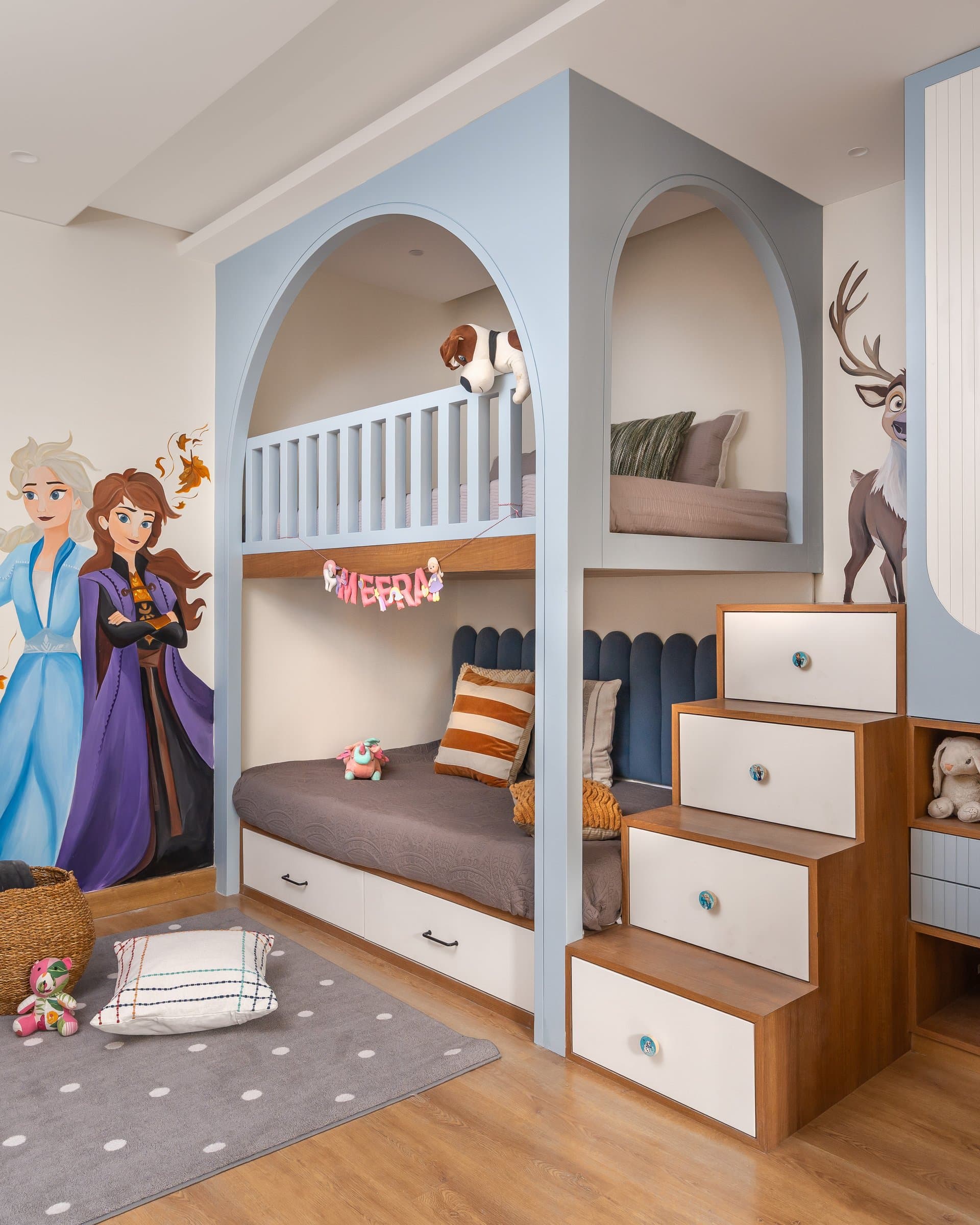 The children's room: a built-in bunk framed by powder-blue arches and a hand-painted Frozen mural