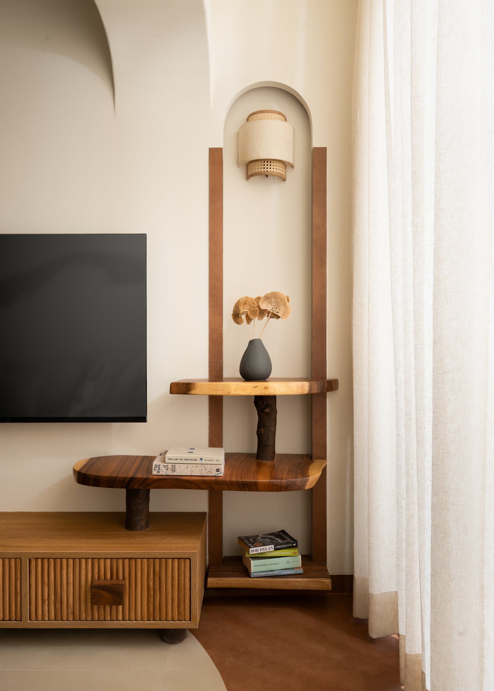 A timber-framed niche with a rattan sconce, the kind of detail that turns an apartment into a home