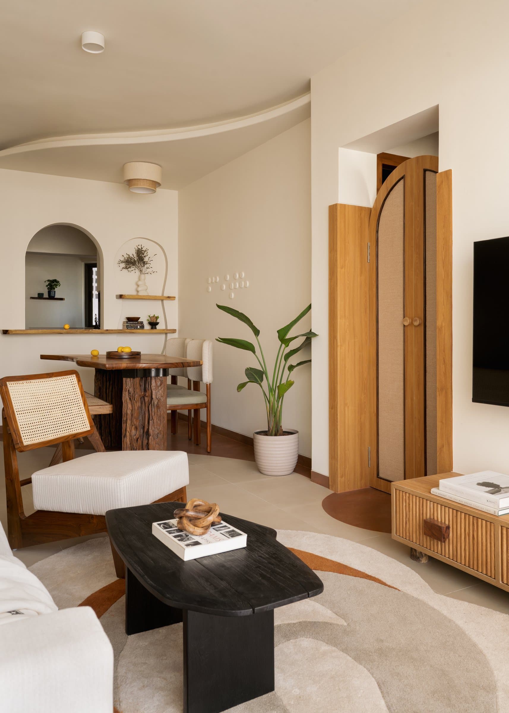 The dining alcove in conversation with the living room, anchored by a trunk-based table