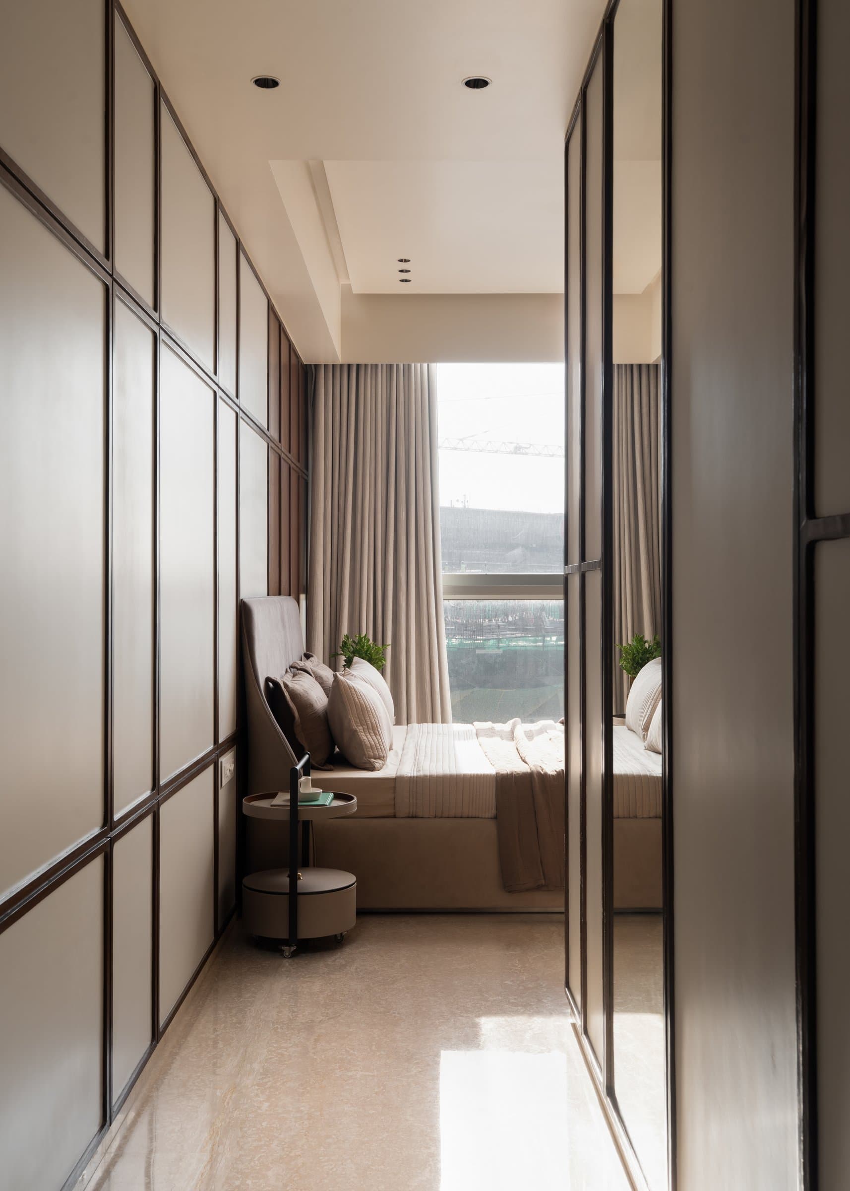 The walk-in dressing alcove, terminating in a window-seat daybed in soft mocha velvet