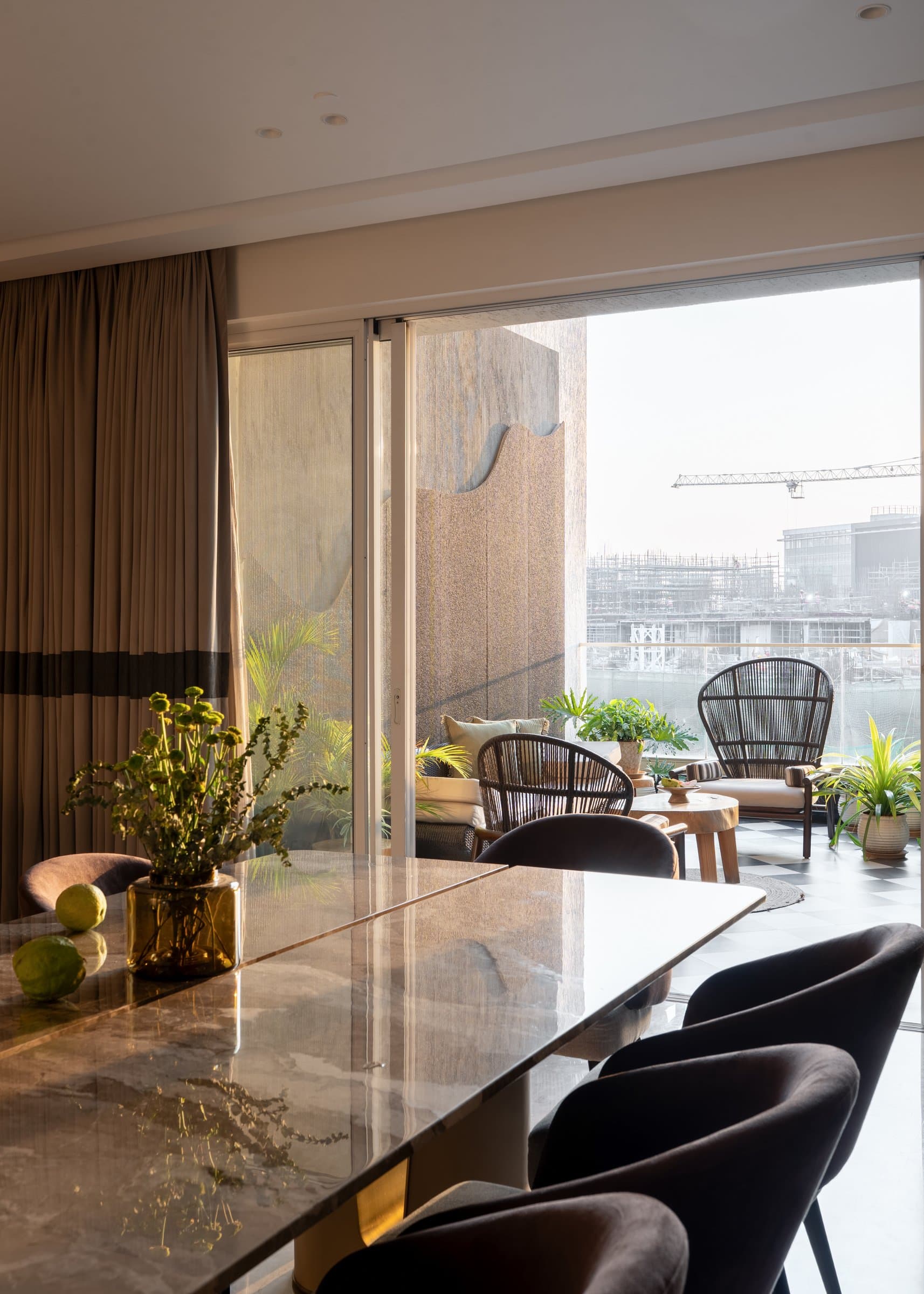 From the dining table, the apartment opens onto the balcony through a wide glazed wall