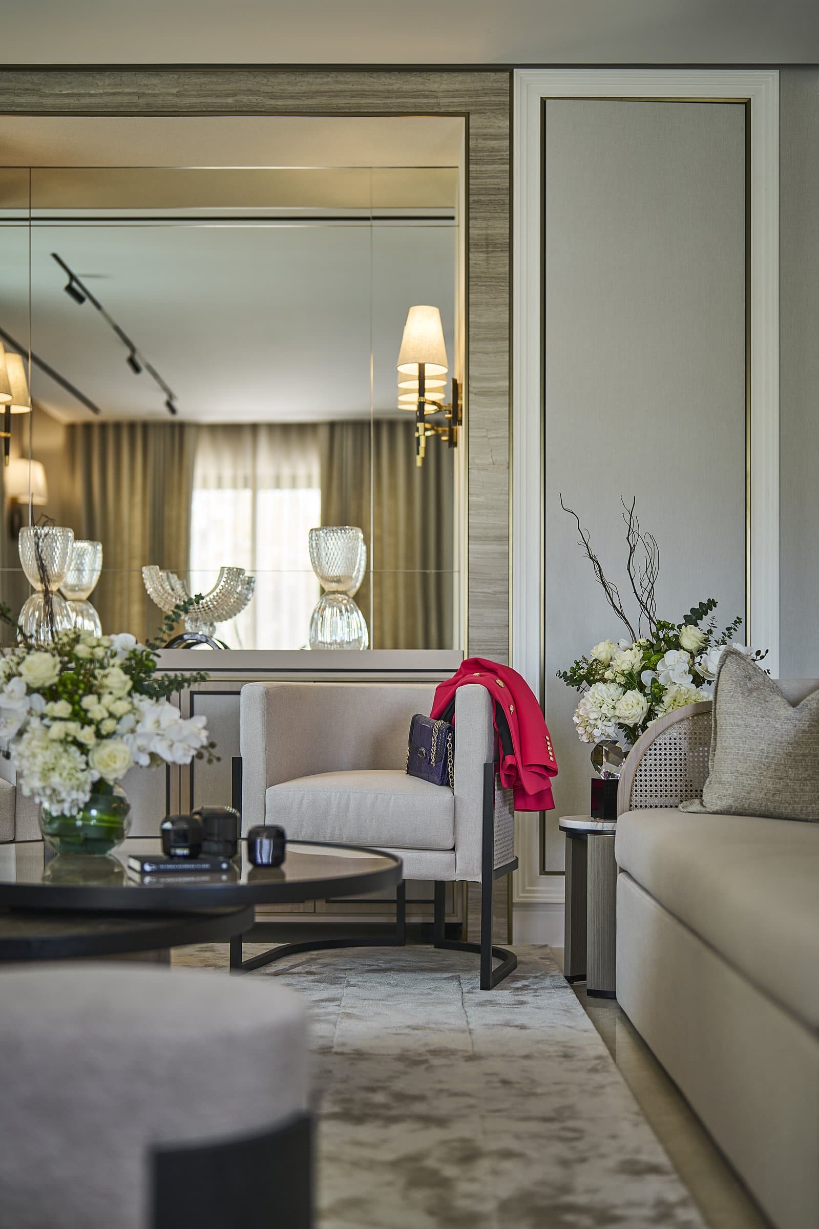 A second view of the lounge: mirrored panelling, viscose underfoot, and the residue of a life lived in the room