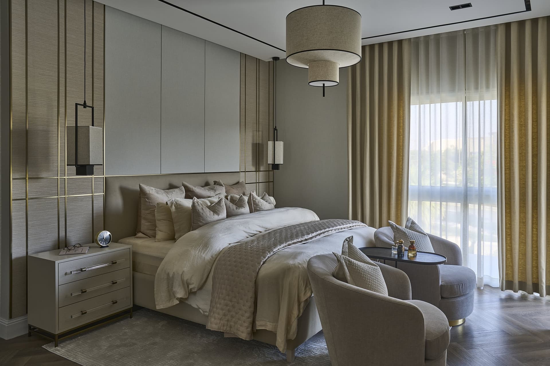 In the master bedroom, a grasscloth wall traced with brass becomes drawing rather than ornament