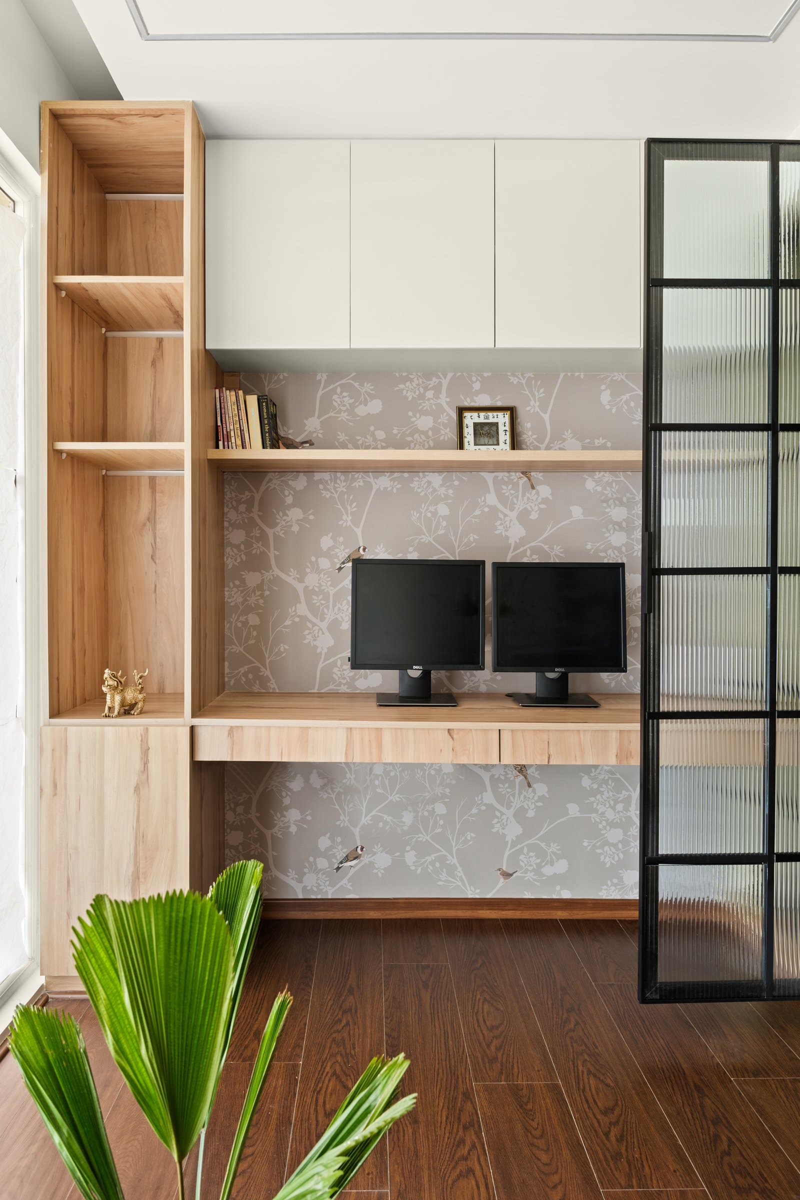 The home office, separated by a fluted-glass partition that keeps light moving between rooms