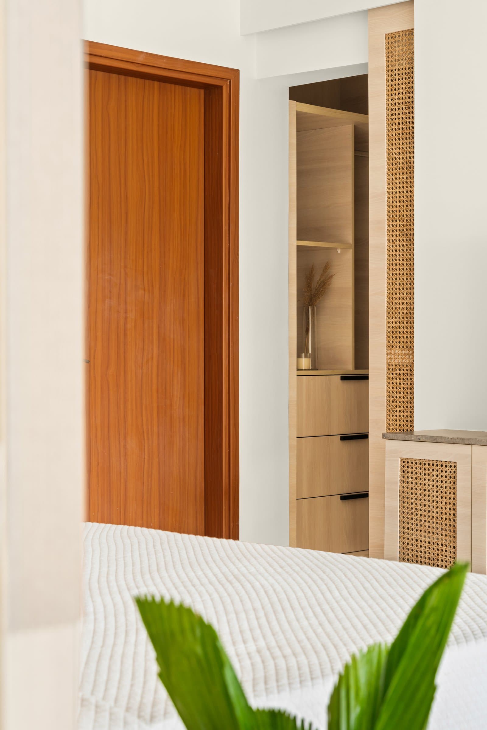 A glimpse into the dressing area, where cane lightens an otherwise dense storage wall