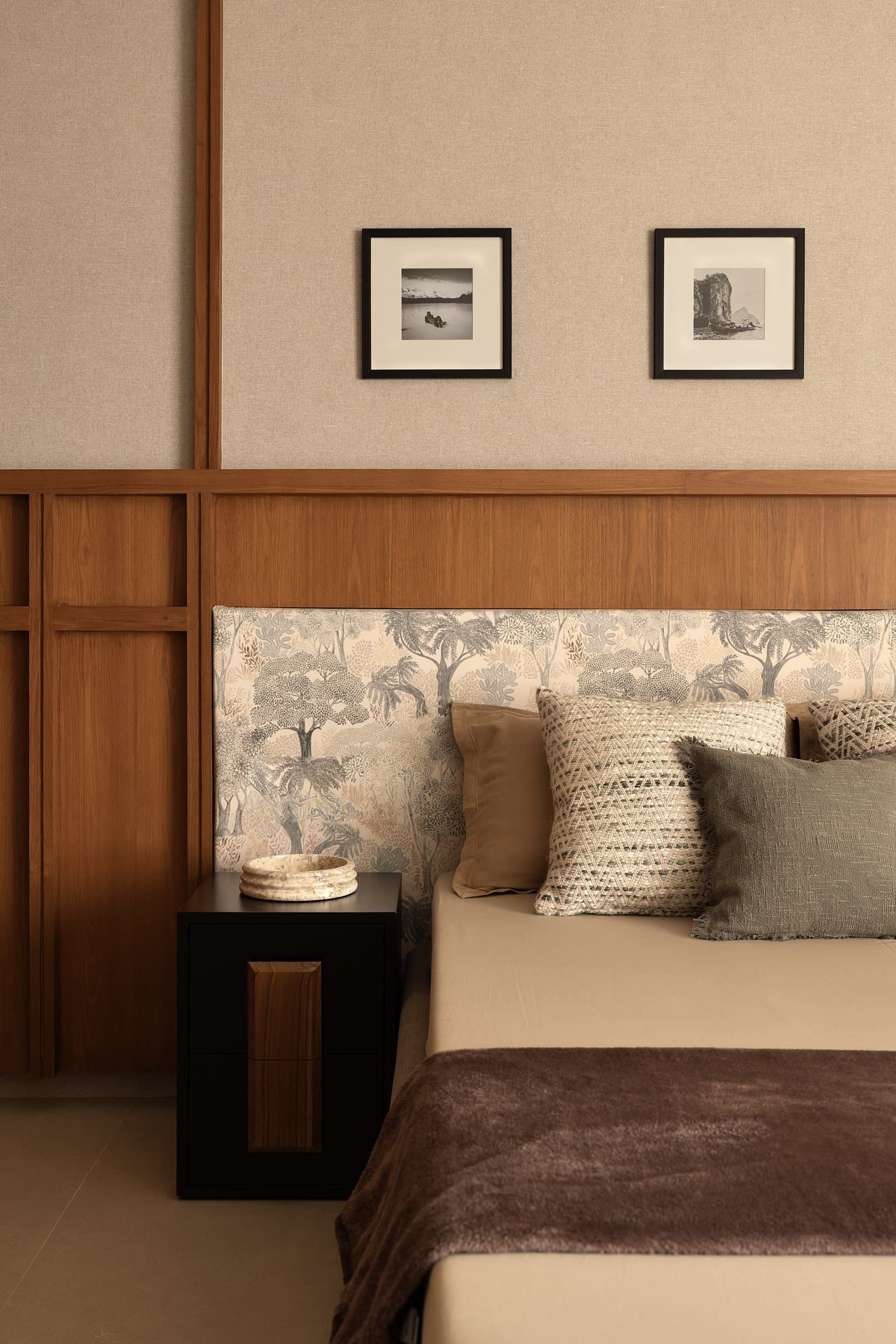 The headboard in closer view: veneer detailed into slim mullions, printed wallpaper set within a clean wood frame
