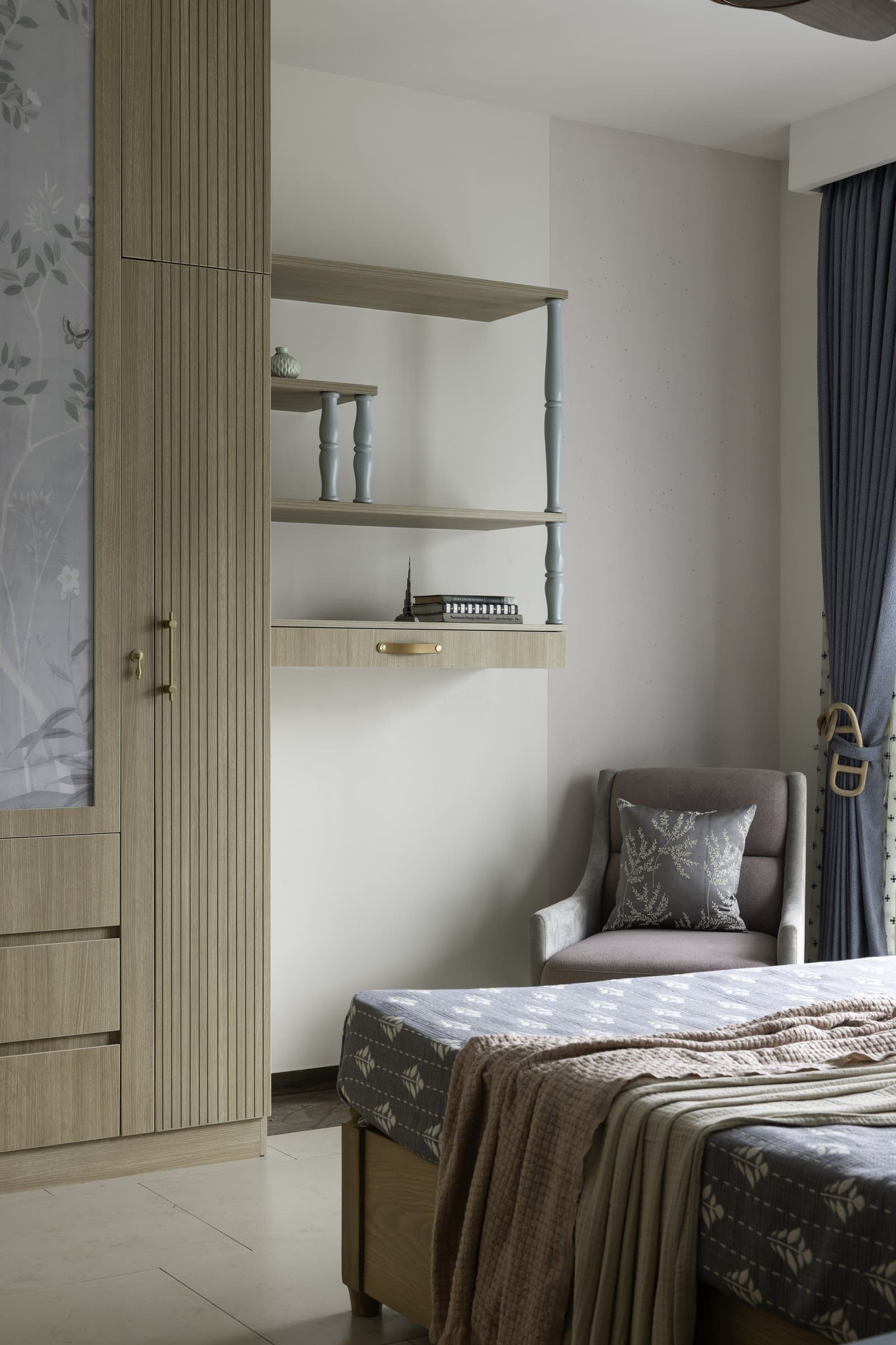 A reading corner where turned blue-grey spindles introduce traditional turnery into an otherwise restrained composition