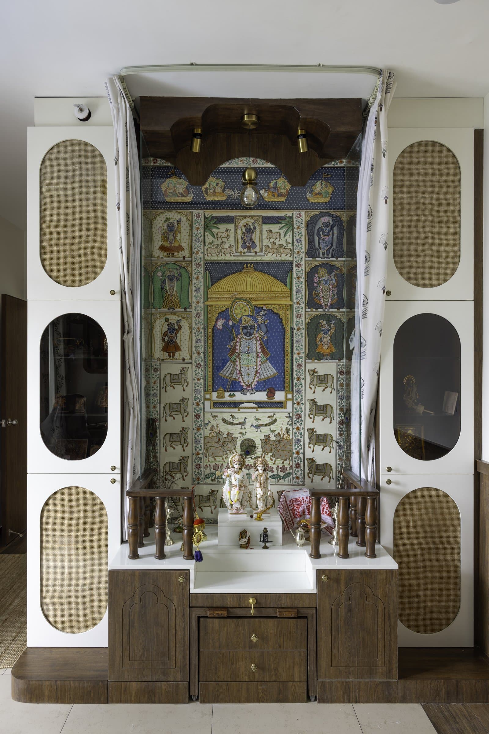 The temple, framed by carved walnut and cane cabinetry, treats ritual as architecture rather than altar furniture