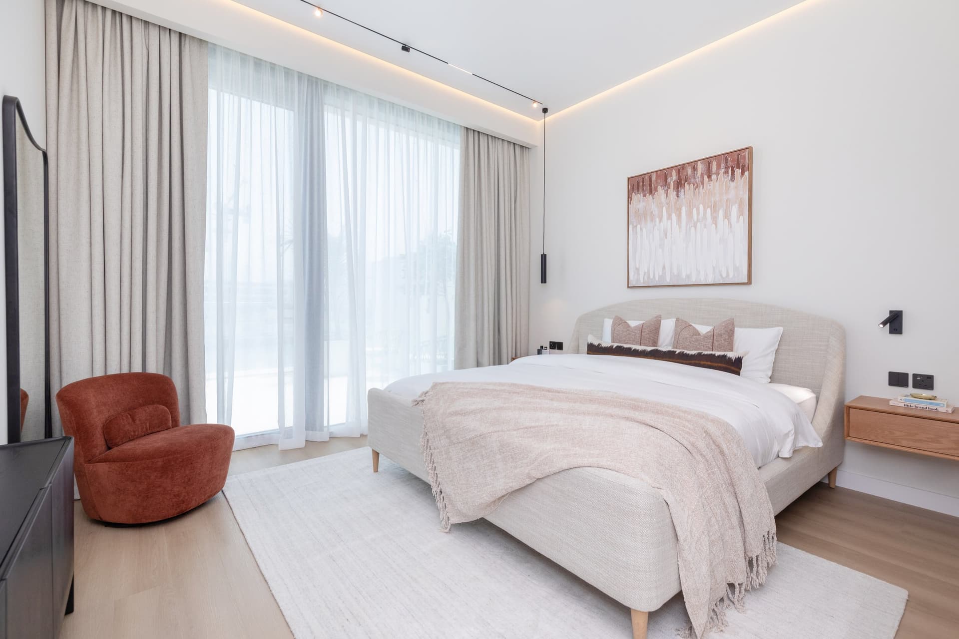 The master bedroom shifts from canal cool to something warmer and more domestic