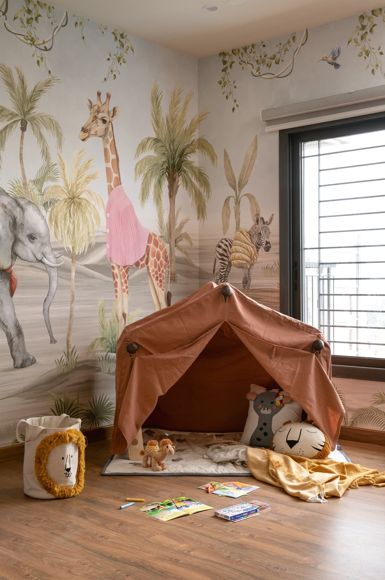 A wooden A-frame draped in rust fabric, tent today, hammock tomorrow, doing the work of several pieces of furniture