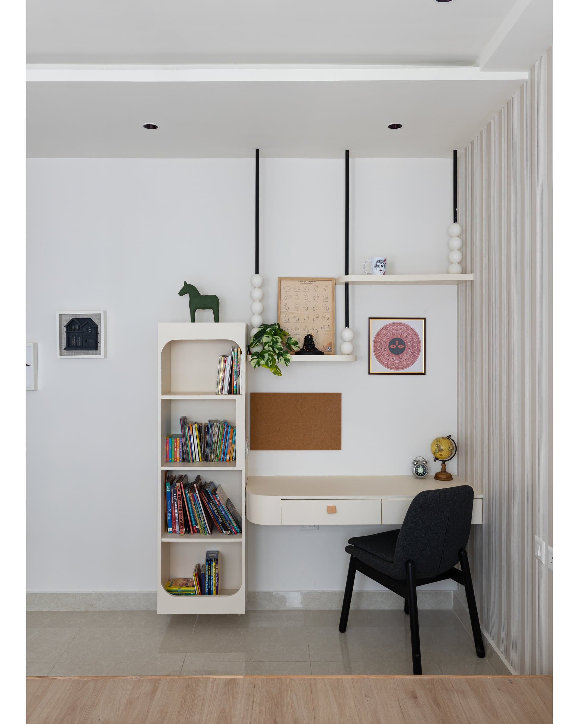 The study corner: wall-mounted desk, rounded-opening bookshelf, and a wooden Dala horse as Nordic reference