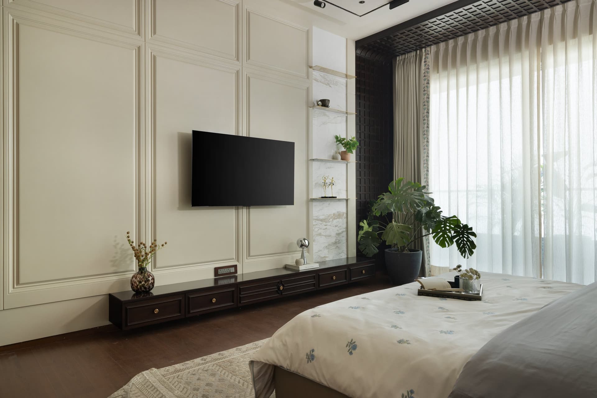 Opposite the bed, a panelled ivory wall and a low ribbed-front console balance classical proportion with contemporary restraint