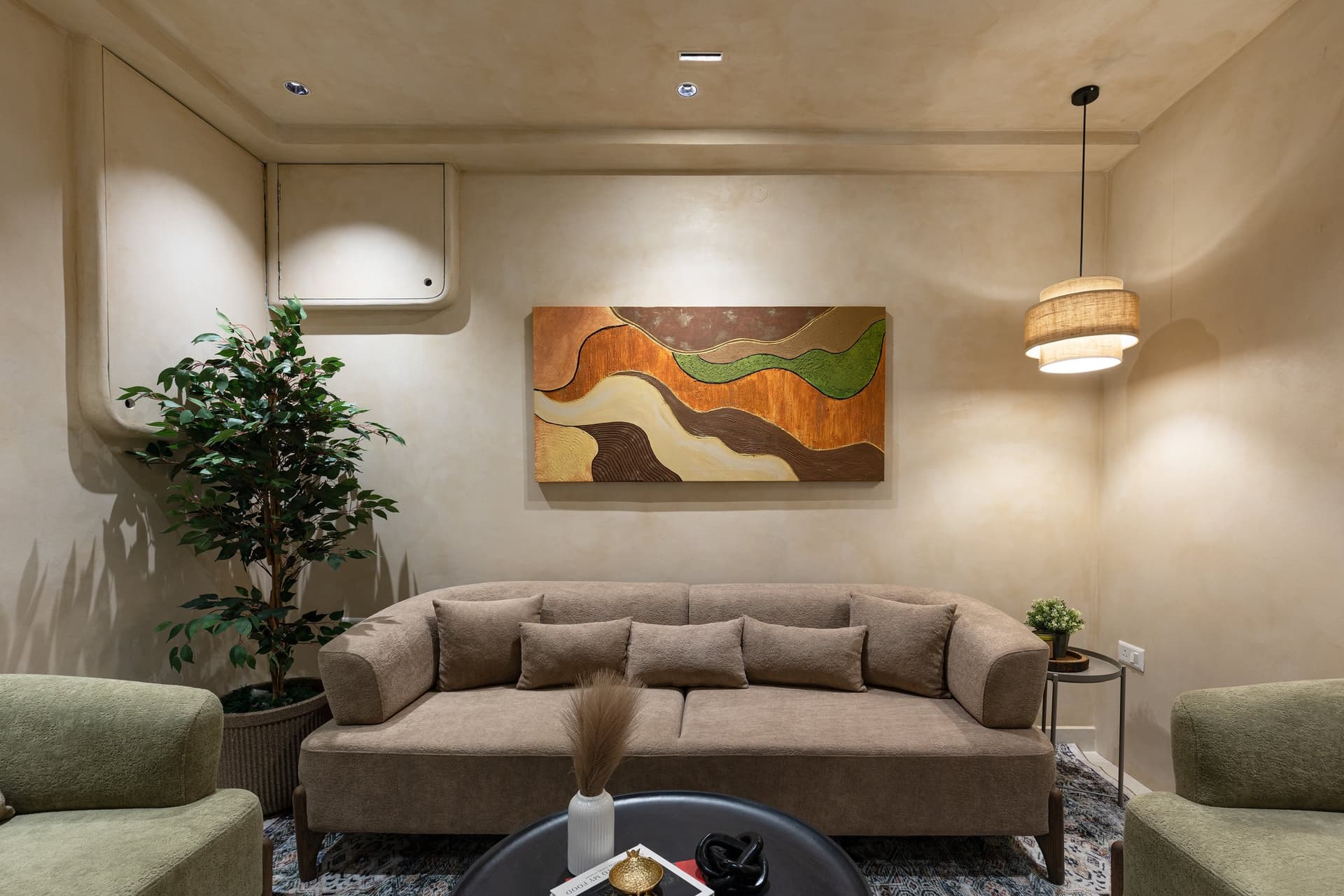 The formal living room, where an earth-toned abstract canvas gathers the home's full palette into a single frame