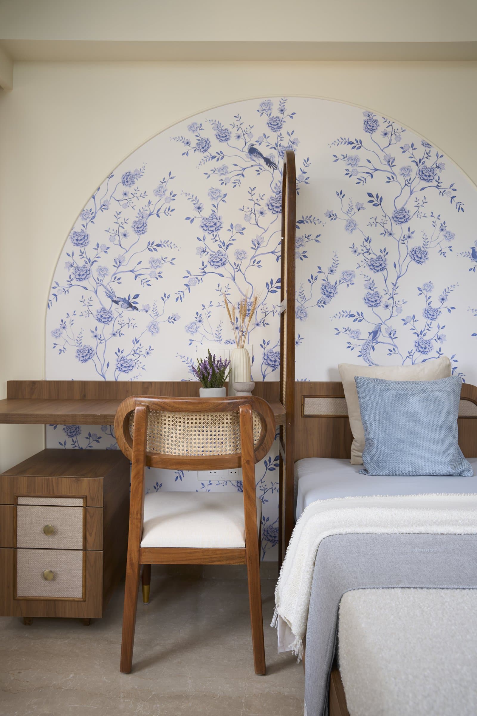 The daughter's room, where a blue-and-white floral wallpaper shifts the home's palette to a younger register