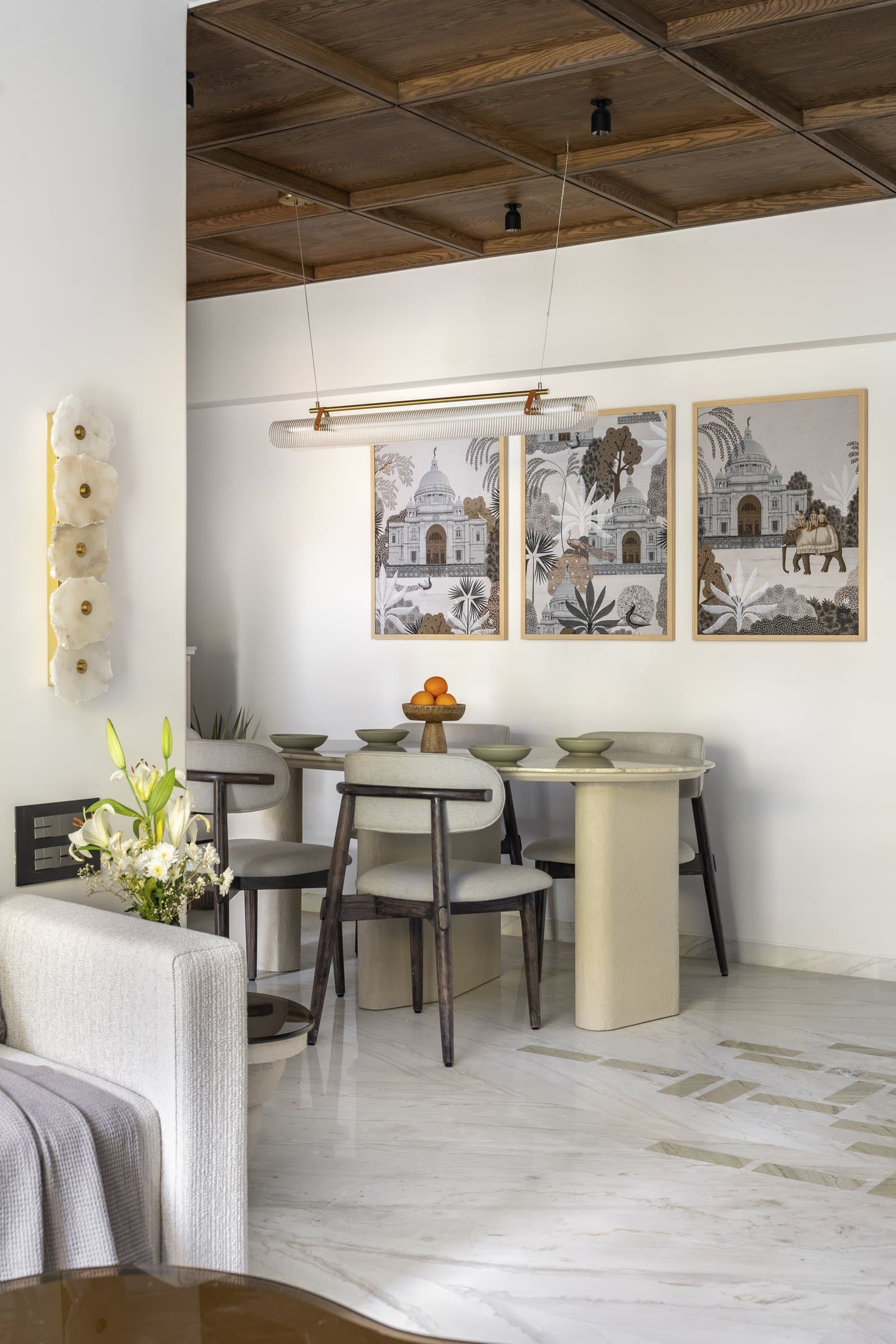 The dining area, set beneath a coffered fumed-oak ceiling that lowers the volume into something more intimate
