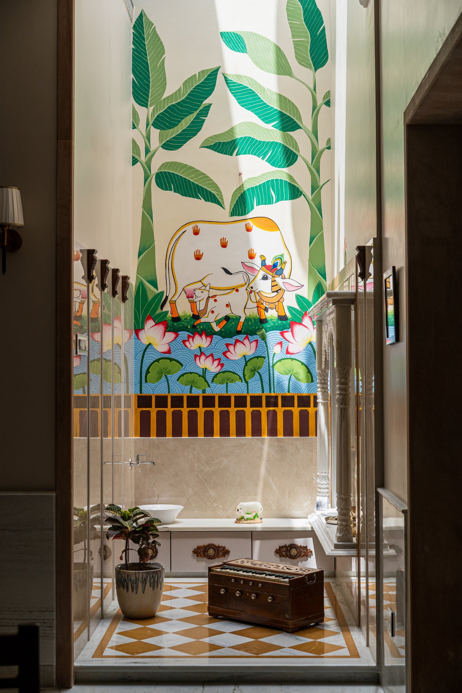 The pooja room: a hand-painted mural of banana fronds, sacred cows and lotus blooms designed exclusively for the residence