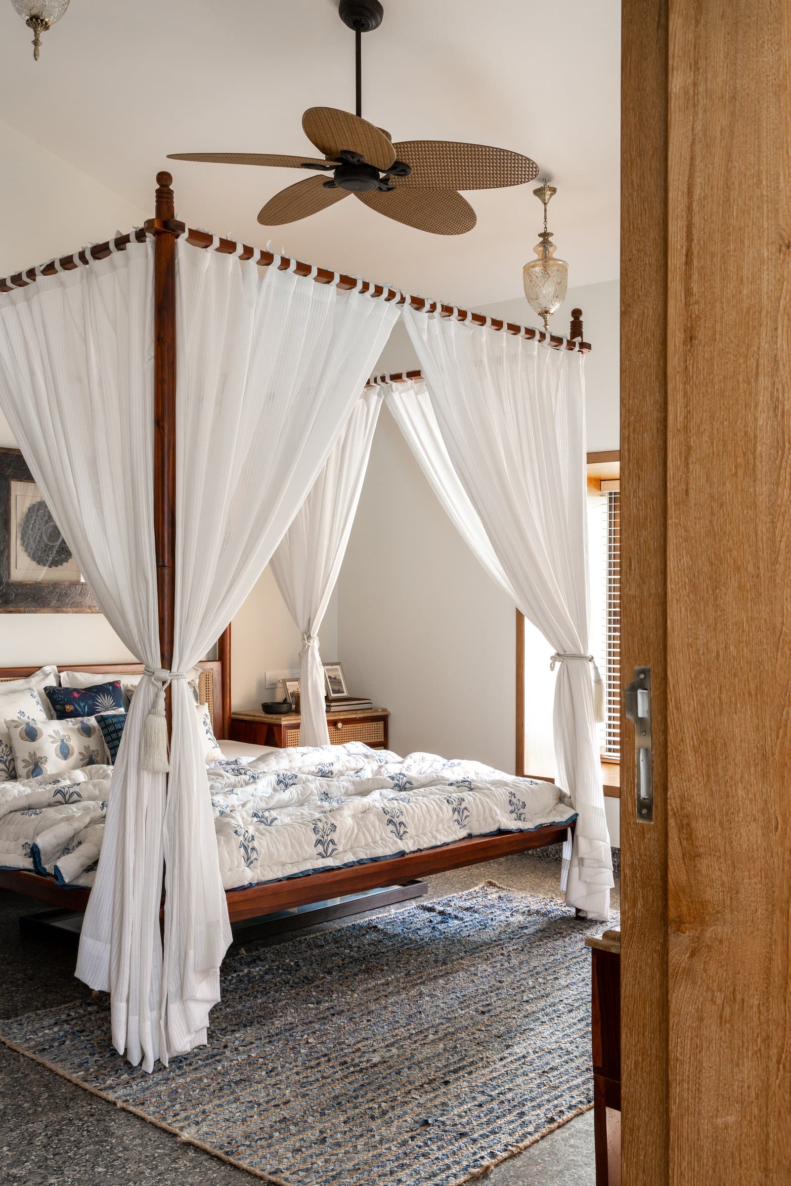 The master bedroom: a four-poster bed draped in sheers, the home's one permitted flourish