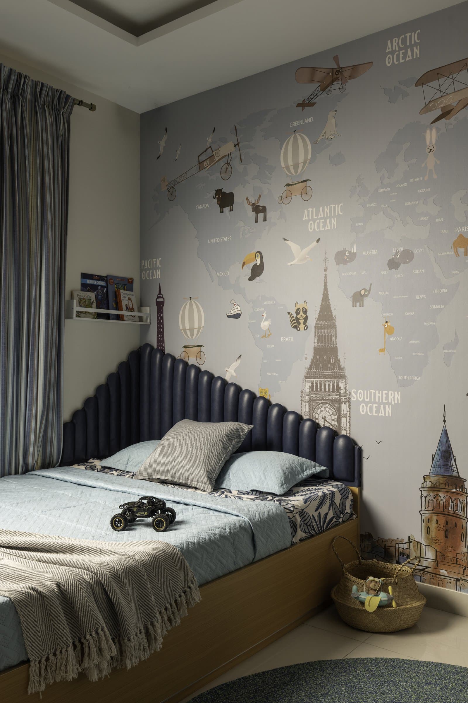 The child's bedroom: a world-map mural and a channelled deep-blue platform-bed headboard