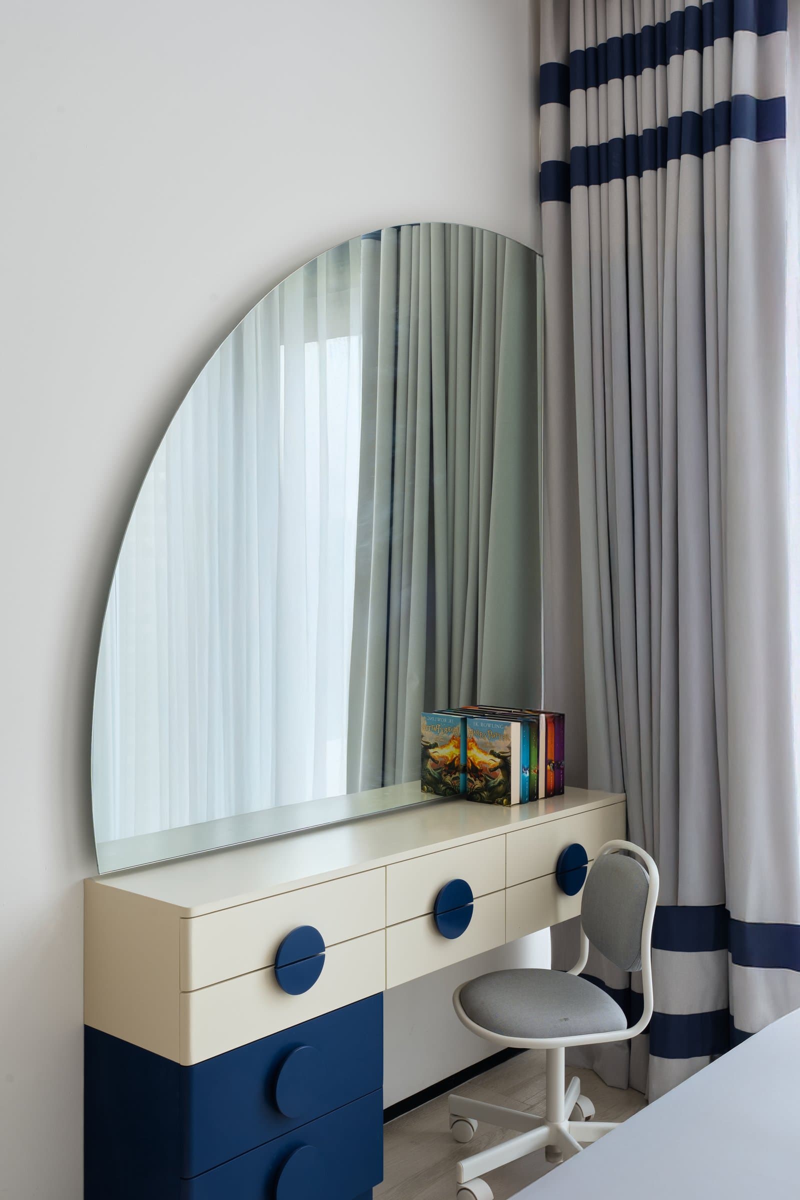 The custom cream-and-cobalt vanity, the one moment in the home where decoration is permitted to be loud
