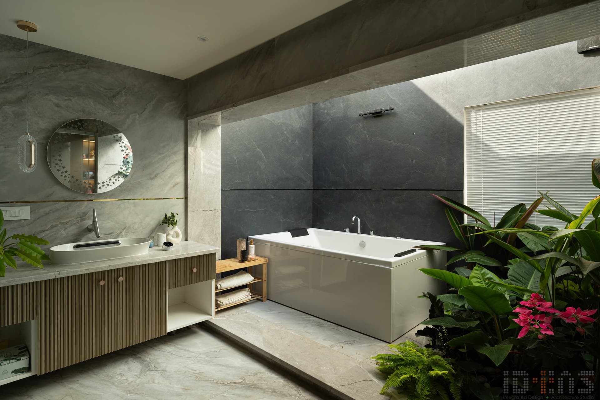 The principal bathroom: a planted bed inside the bathroom envelope makes the home's tropical thesis explicit