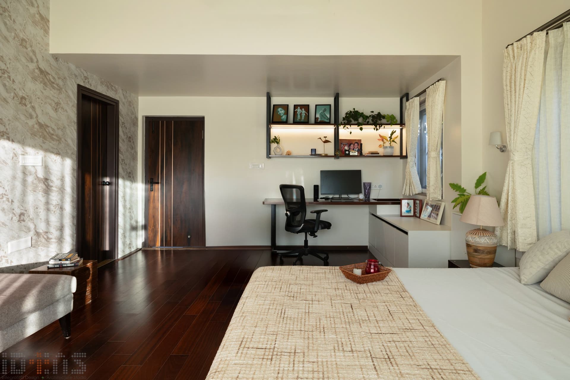A built-in study desk and floating display shelf bring the same restraint to the room's working corner