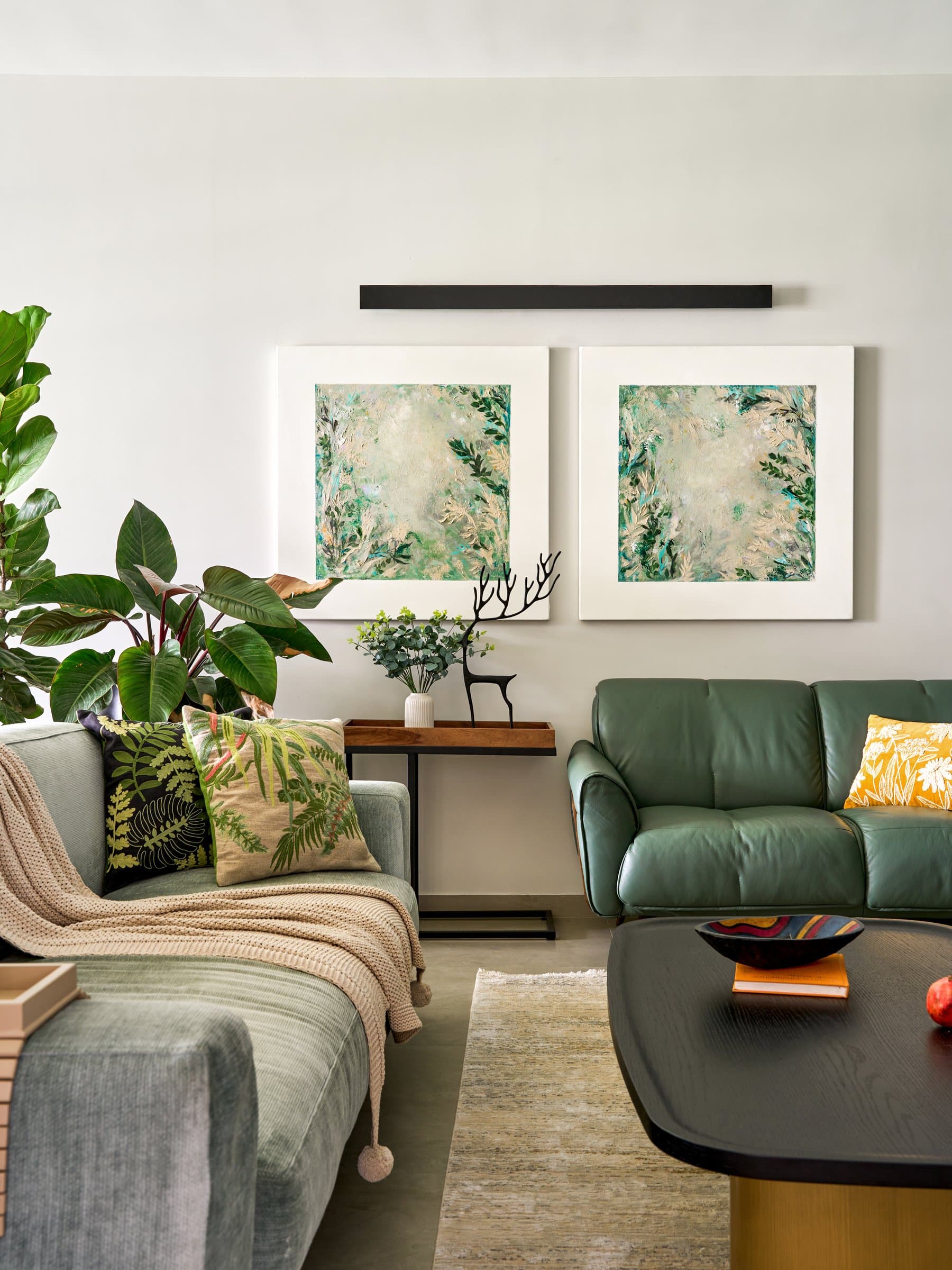 The botanical diptych above the wood-toned console, establishing the living room's tonal key