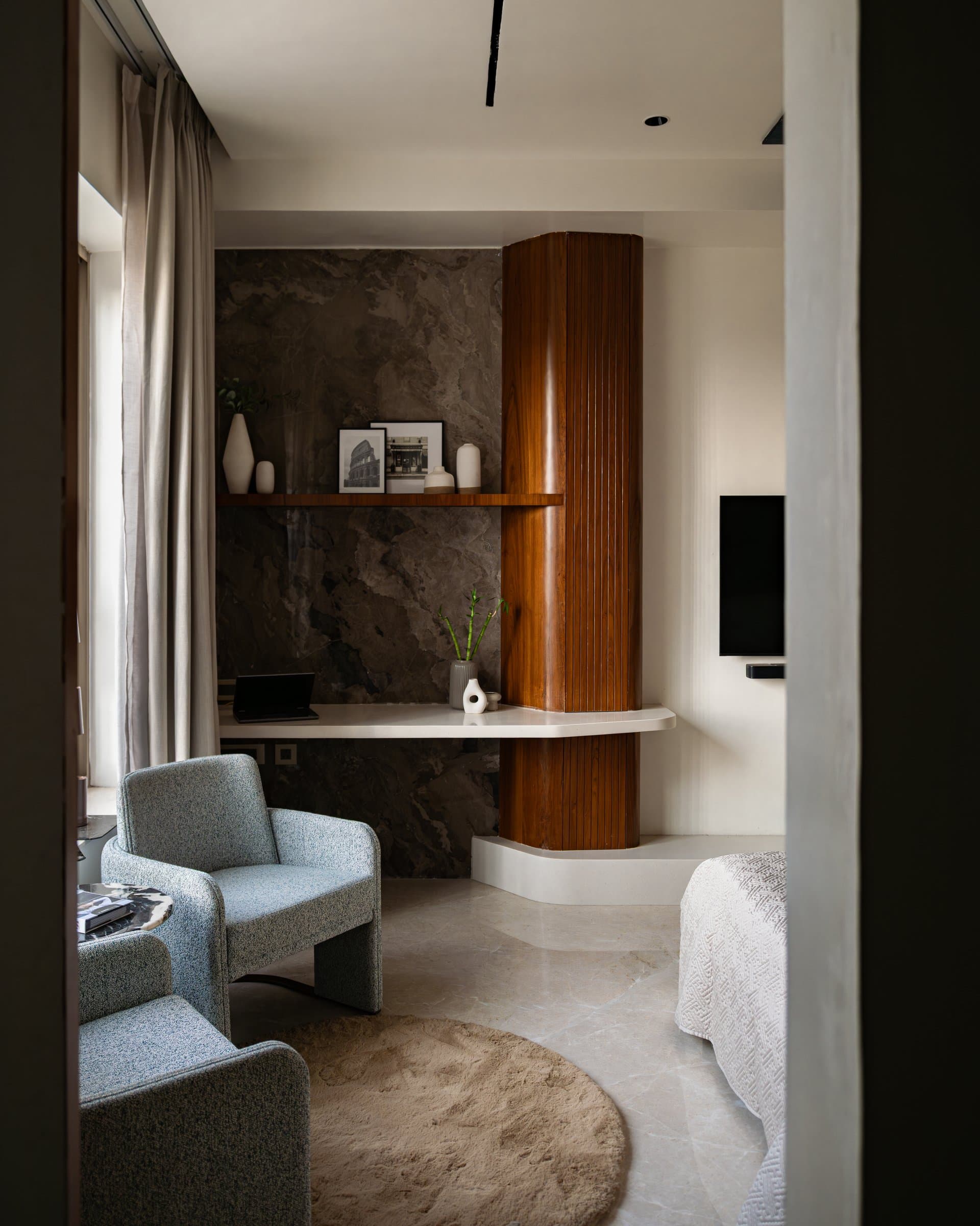 Within the master suite, a fluted teak column wraps a structural element beside a cantilevered study ledge