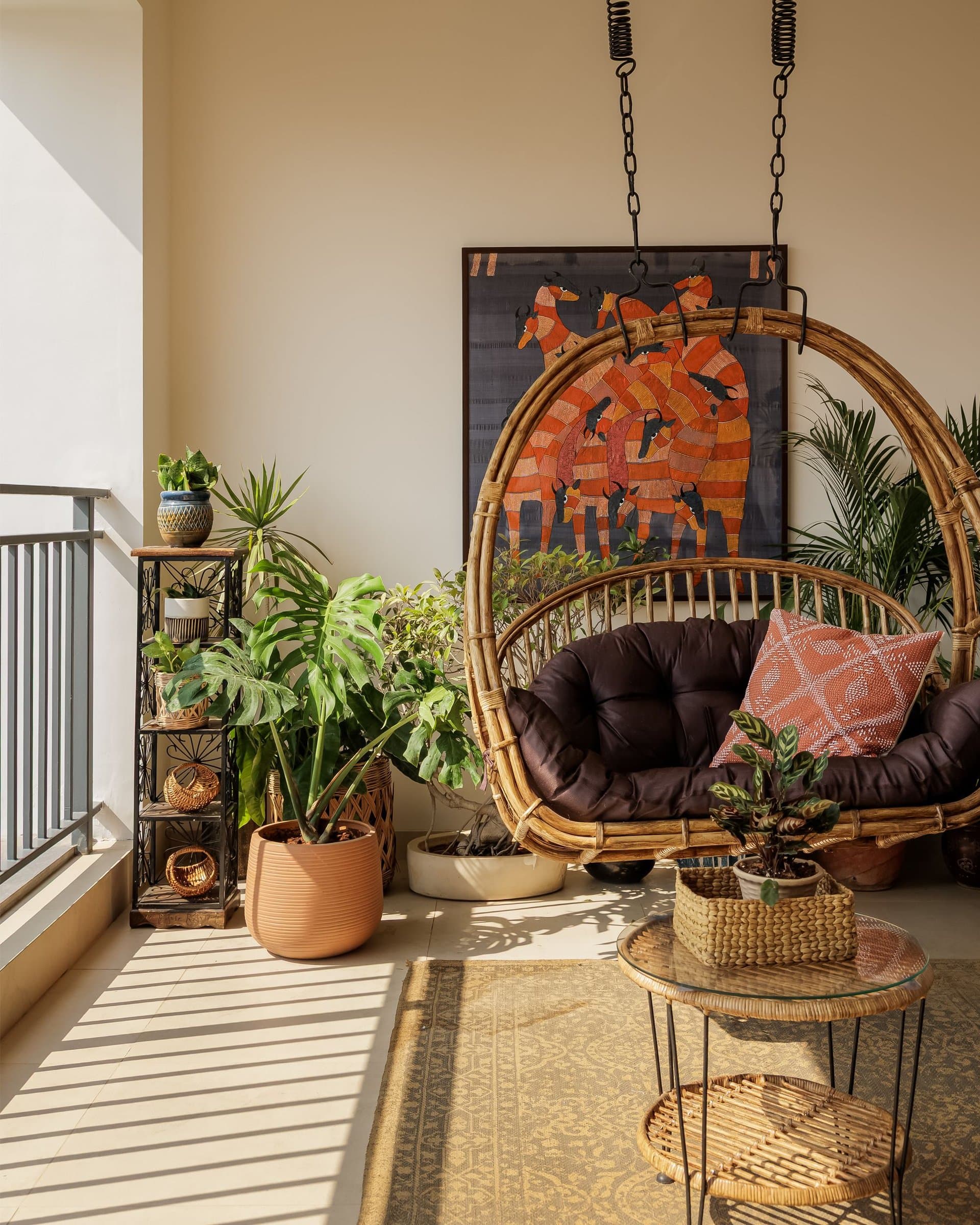 The balcony, where a rattan hanging swing and a folk-style artwork close the tour on sun and air