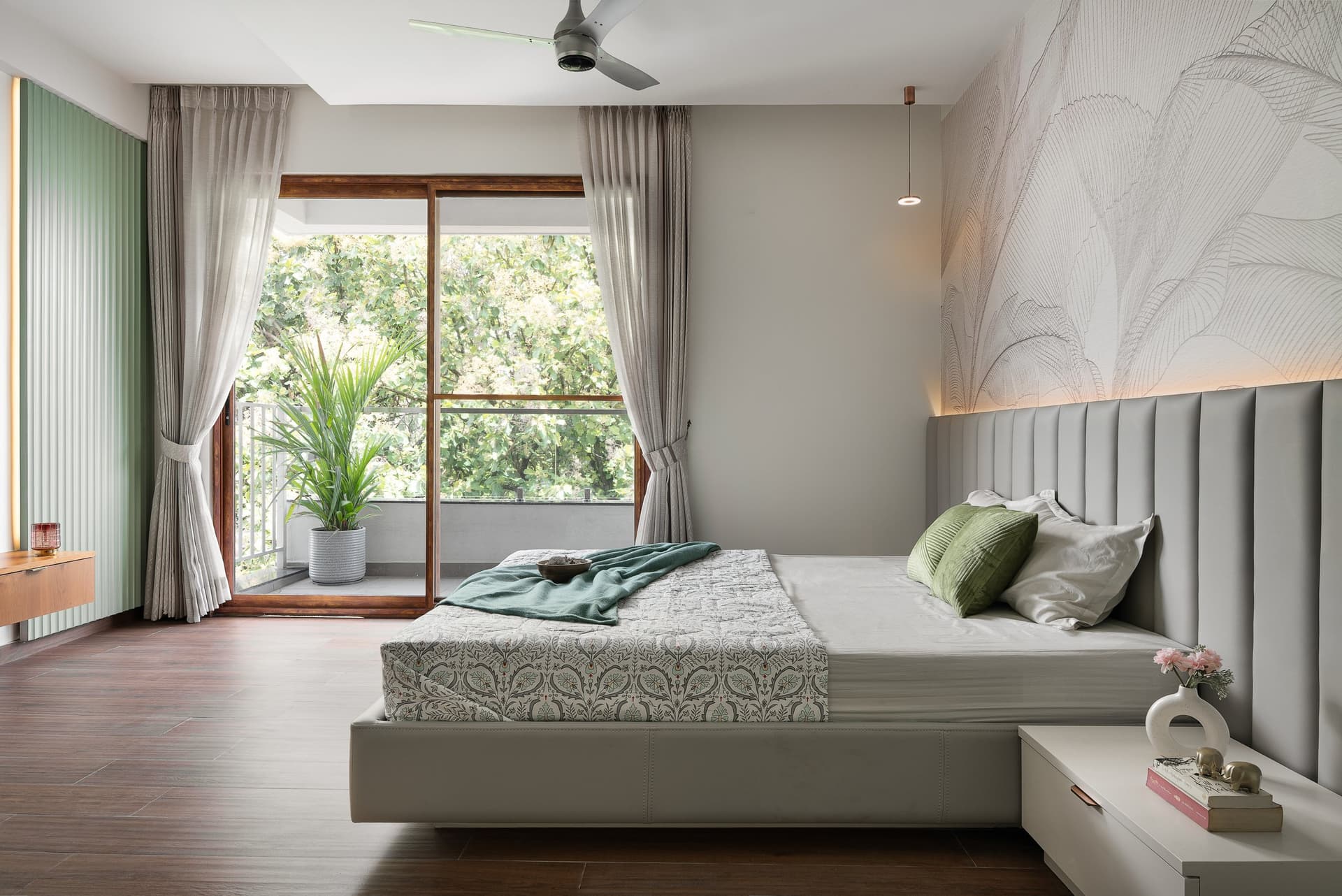The second bedroom, where a botanical mural and mint fluted panel introduce colour as architecture