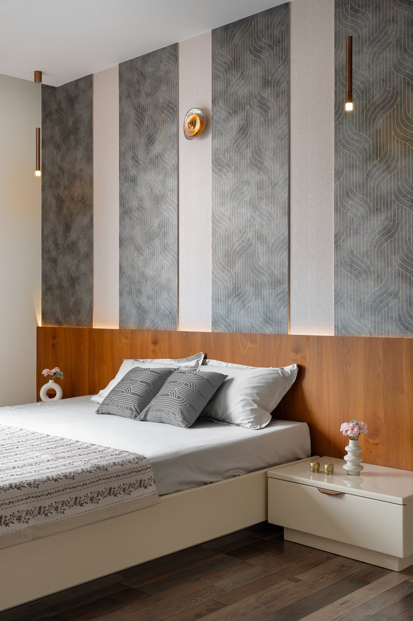 In the master bedroom, alternating linen-textured and patterned panels anchored by a full-width wood headboard