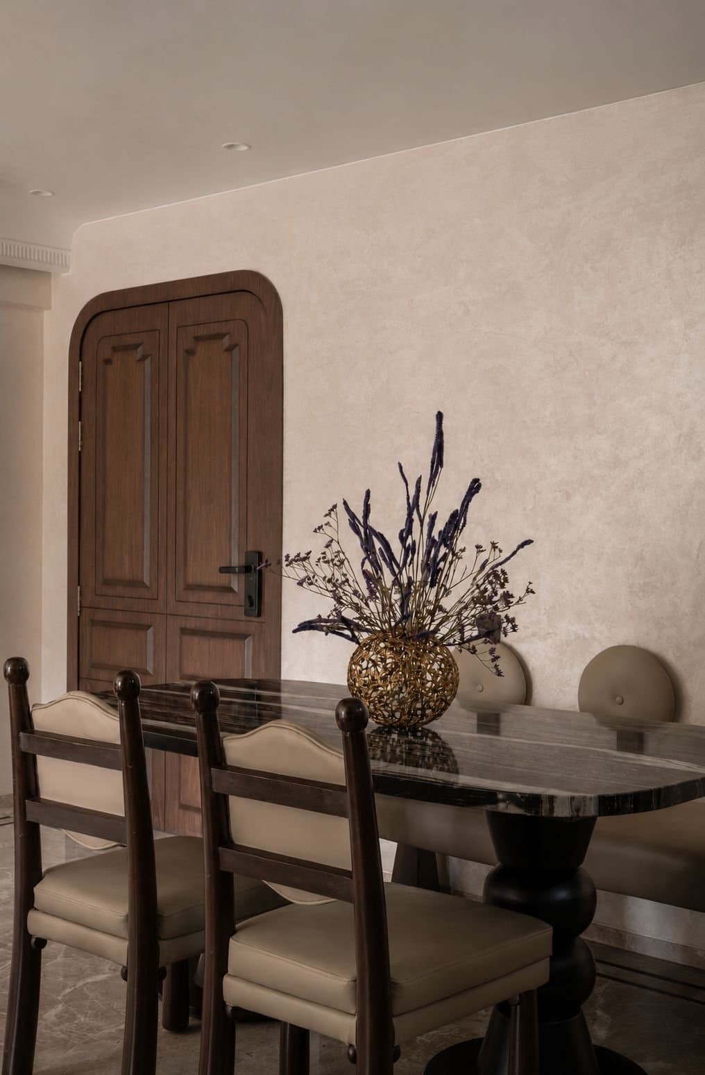 The master bedroom, where rounded edges and a cane panel introduce texture without breaking the calm