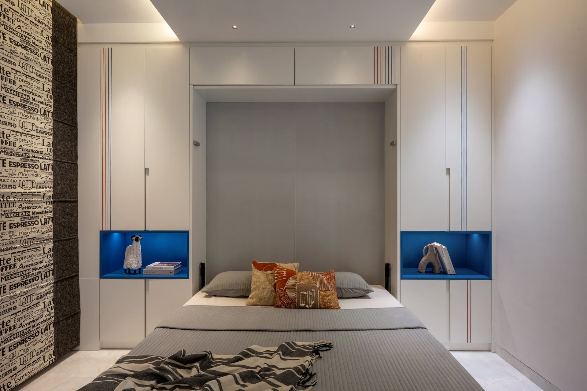 The walk-in dressing room behind the master, where mirrored wardrobes and a backlit vanity mirror do the heavy lifting