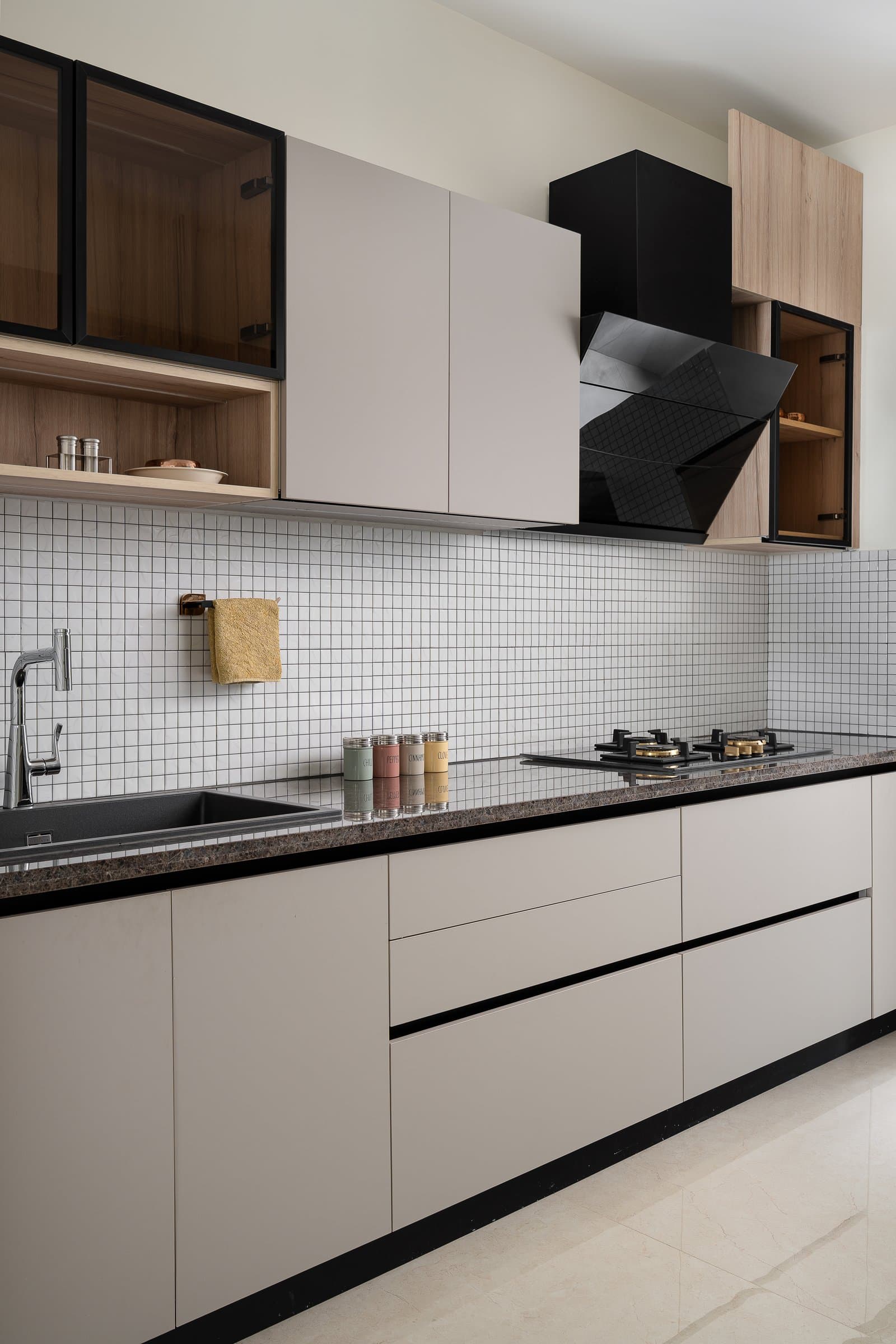 Closer in: a black glossy chimney, the kitchen's only permitted interruption to the matte field