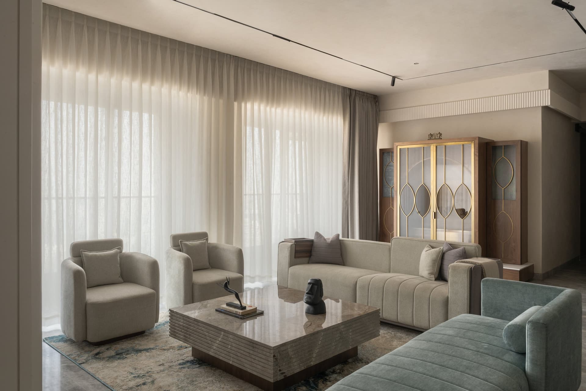 The living room as light-box: sheer drapes, oatmeal upholstery and a single accent of sage velvet