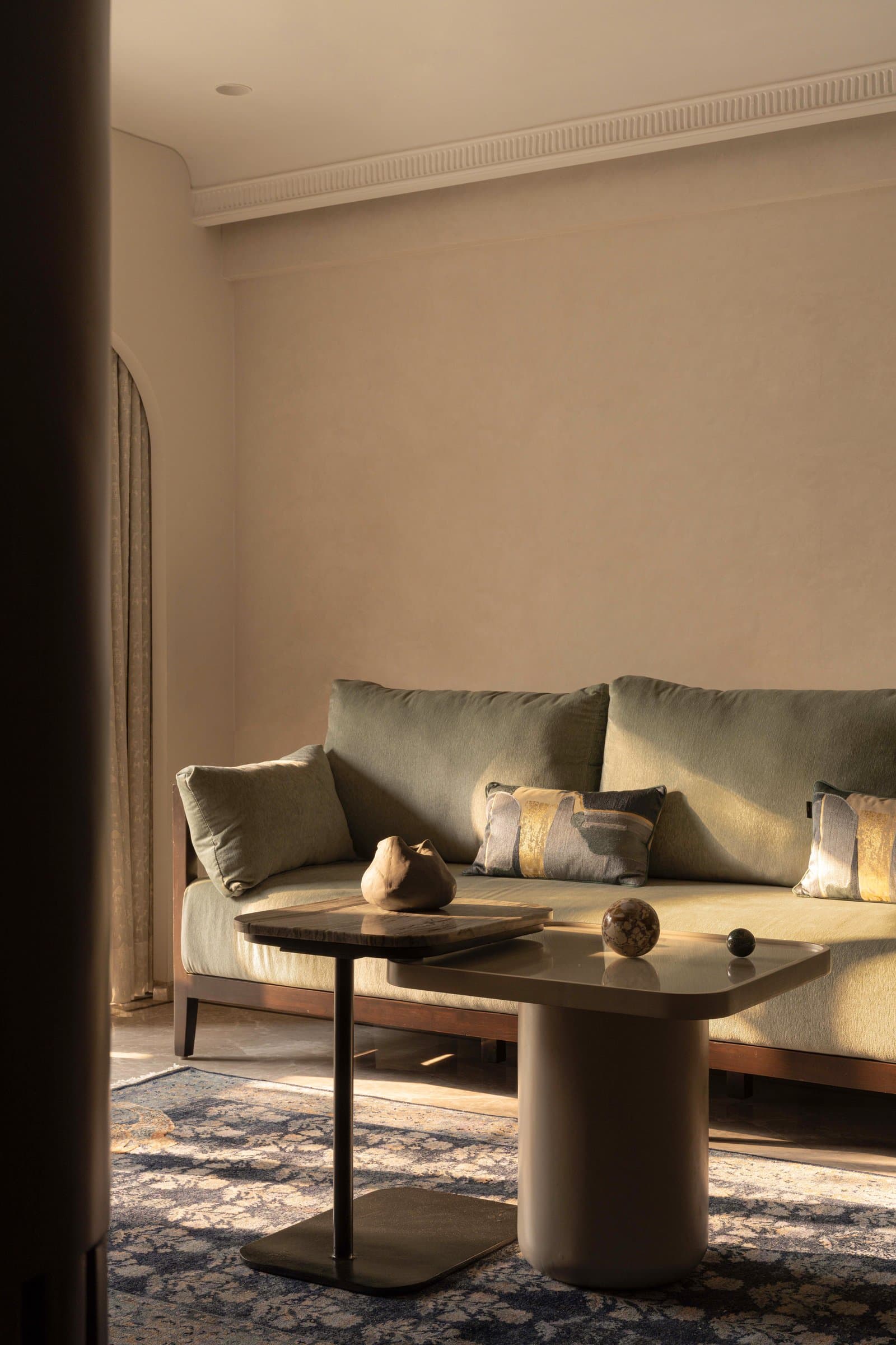 The fluted wood partition that holds the television and conceals the passage to the kitchen