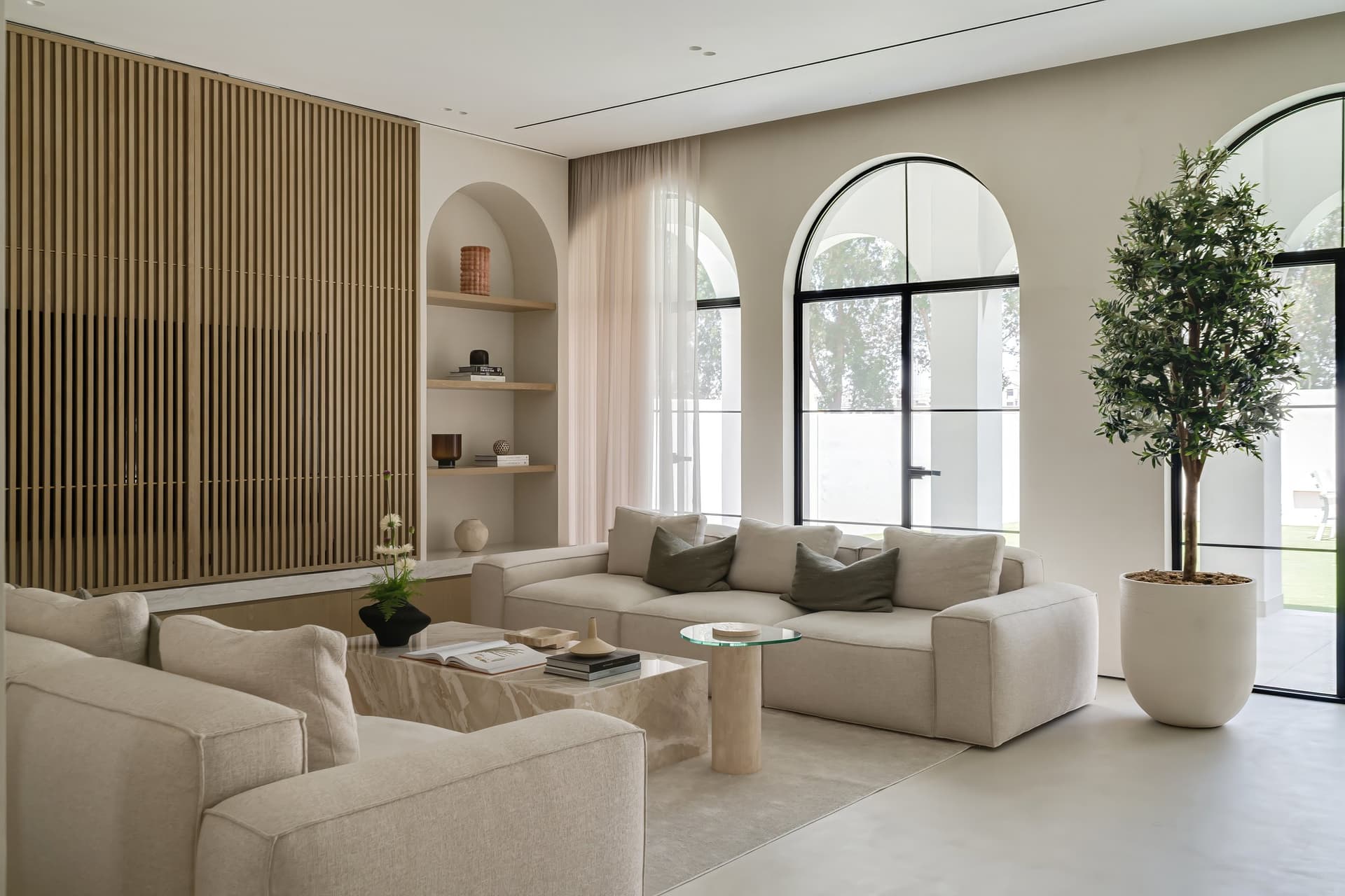 The repeated arch, in joinery and glazing, becomes the thread that ties exterior to interior