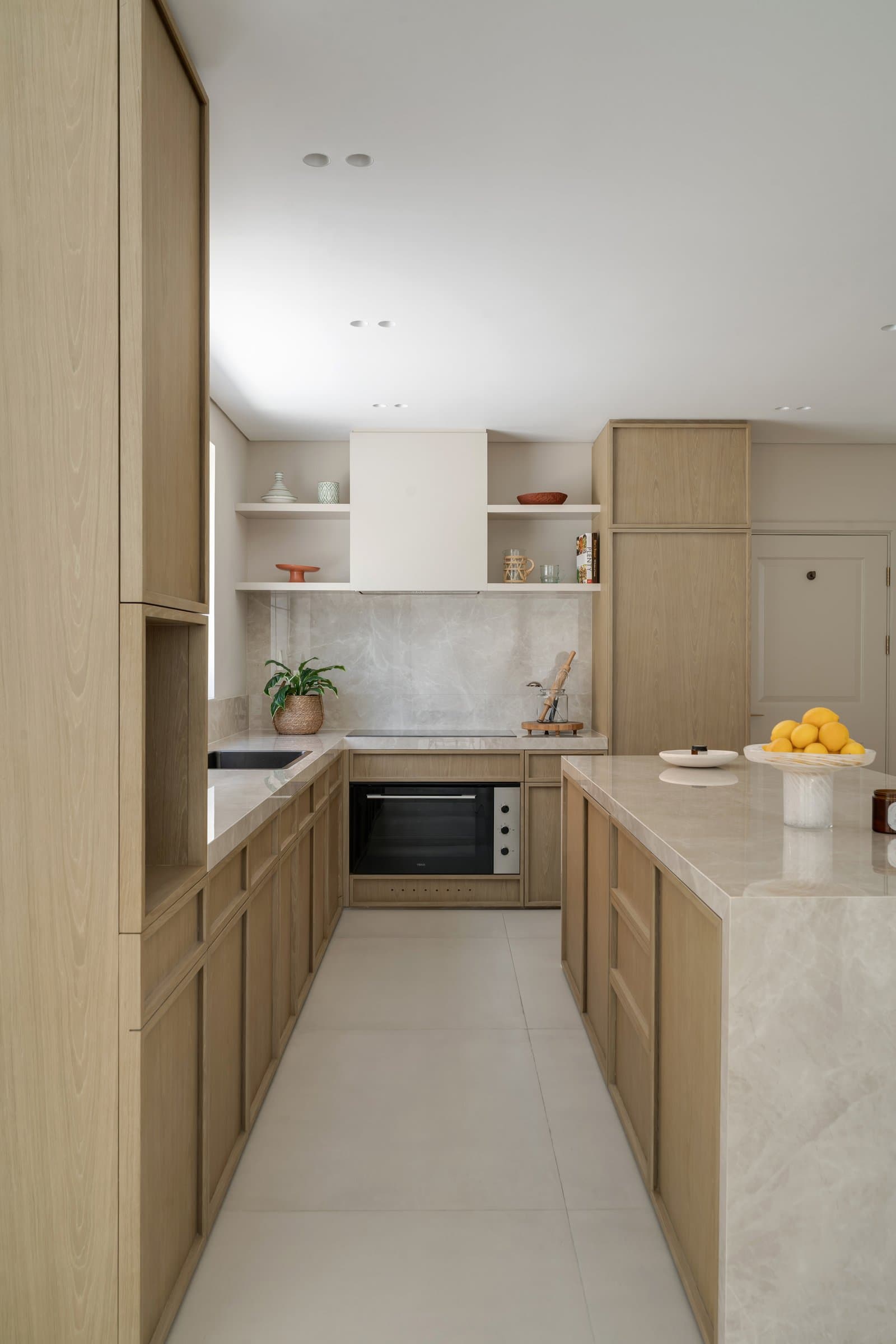 Panel detailing on the bespoke oak cabinetry references traditional joinery in a contemporary register