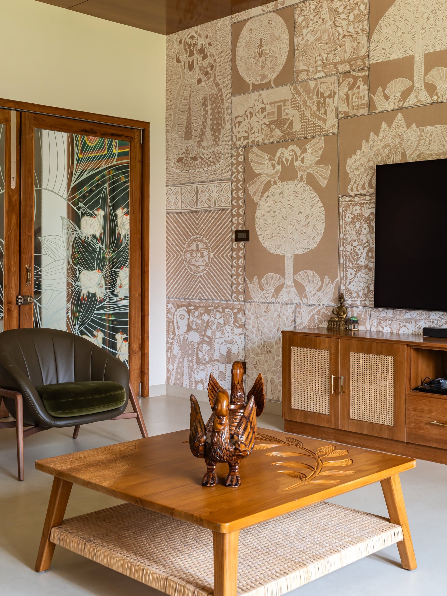 The family living area, where a folk-motif mural in sepia tones carries the home's craft narrative into daily life