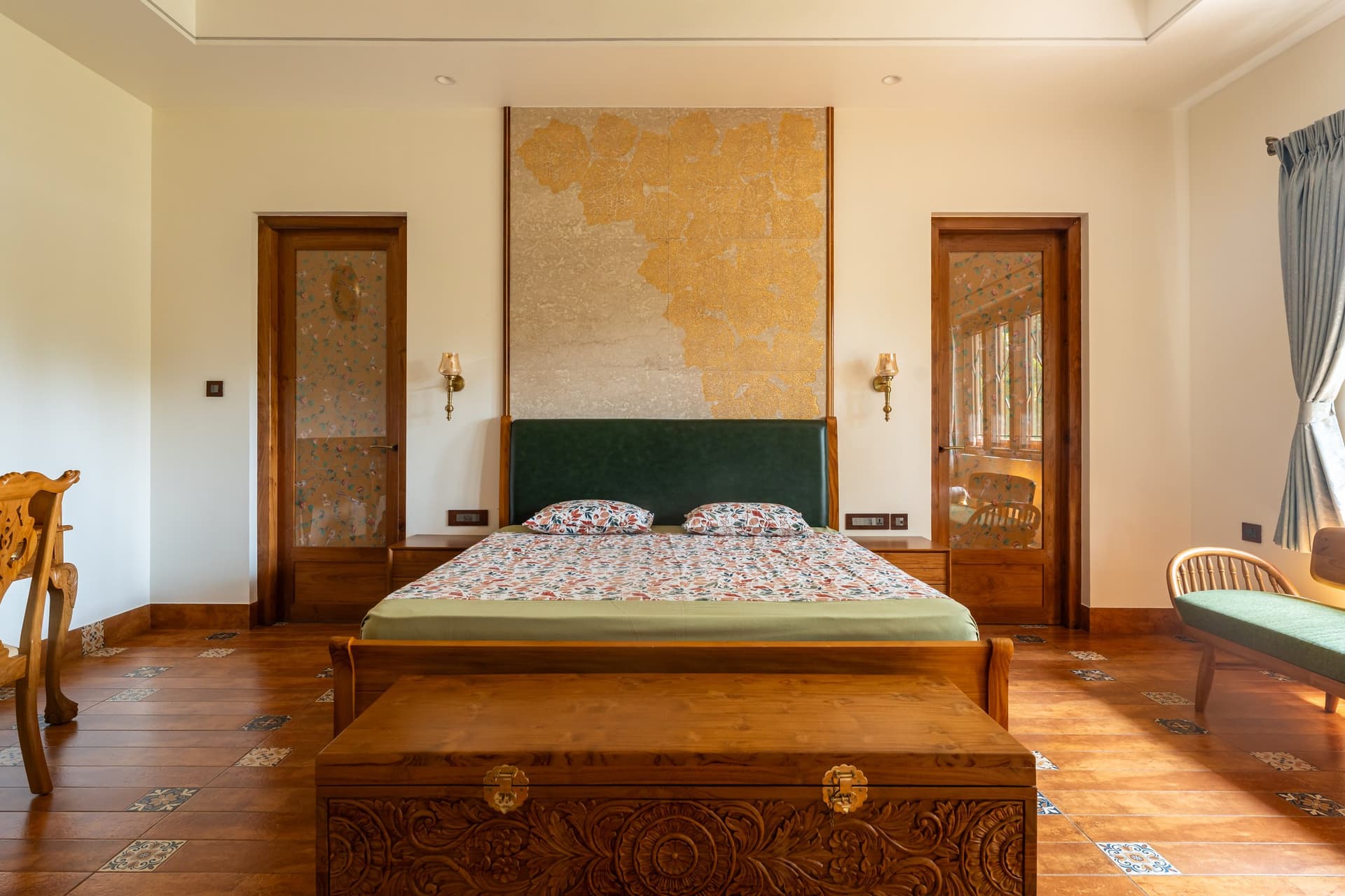 The master bedroom, where pressed leaves from the site are embedded into a stone-toned headboard wall