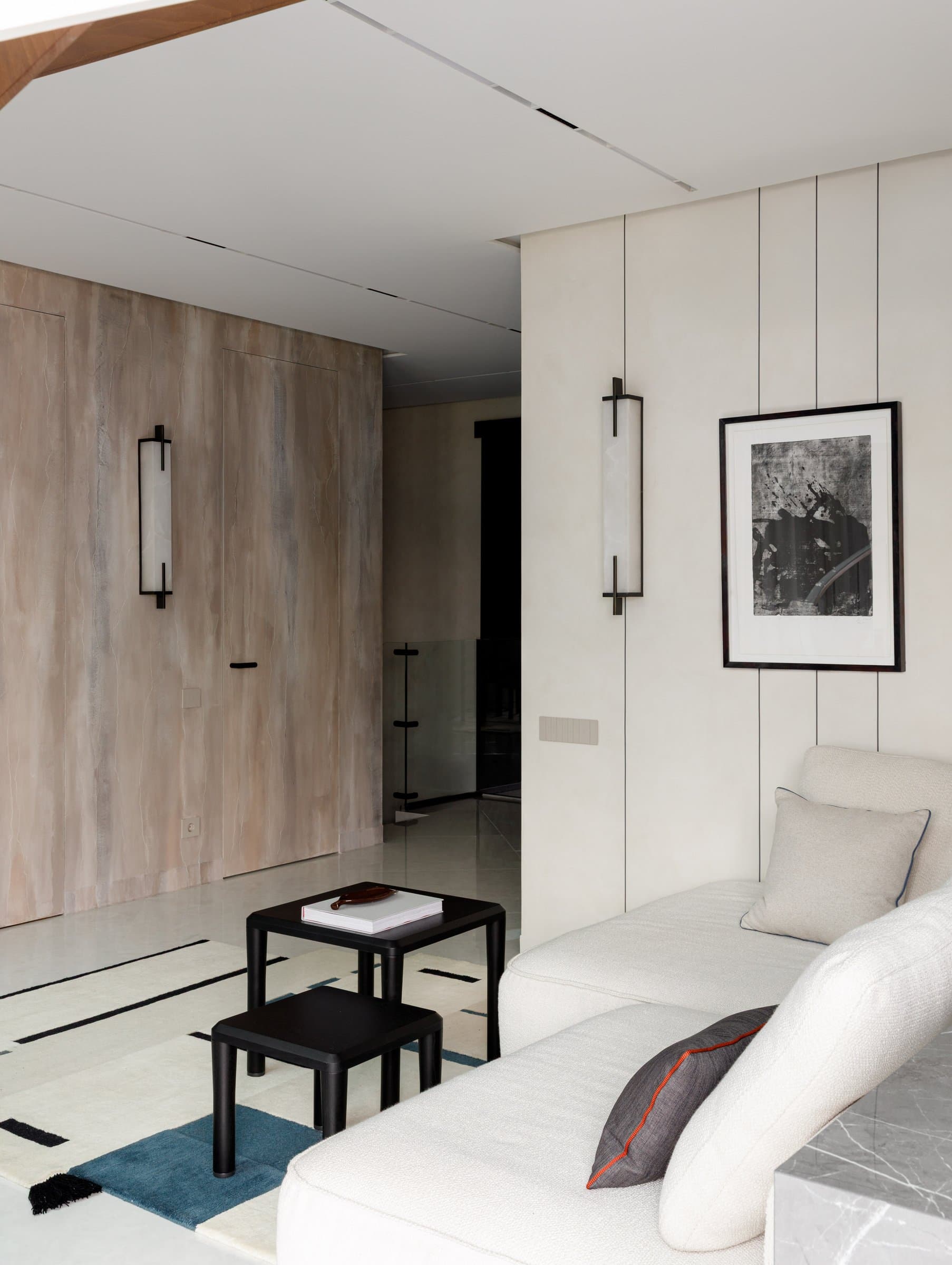 A quieter view of the living area, where the travertine wall conceals a service door