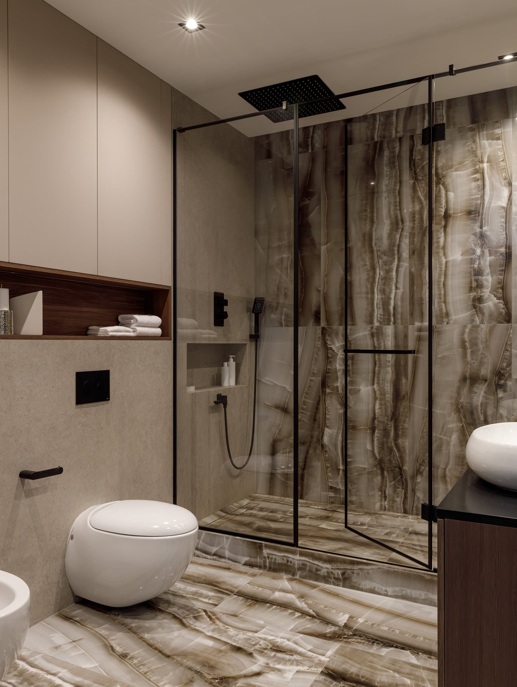 The main bathroom, where a veined stone panel defines the shower enclosure