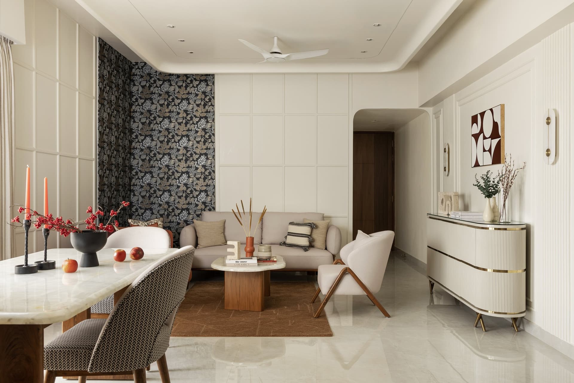 The living and dining volume, where a pale linen sofa and walnut-based coffee table anchor an uninterrupted plan