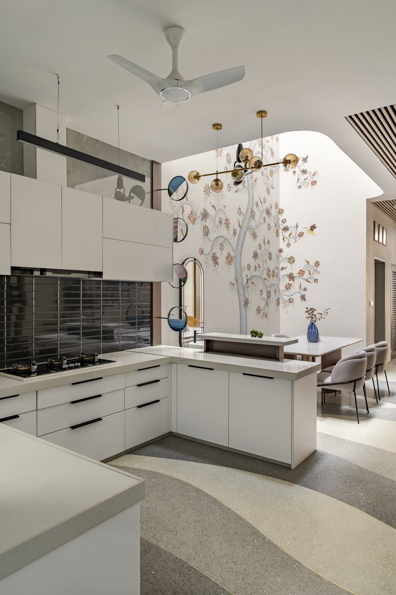 The galley kitchen, where circular portholes borrow light between kitchen and passage