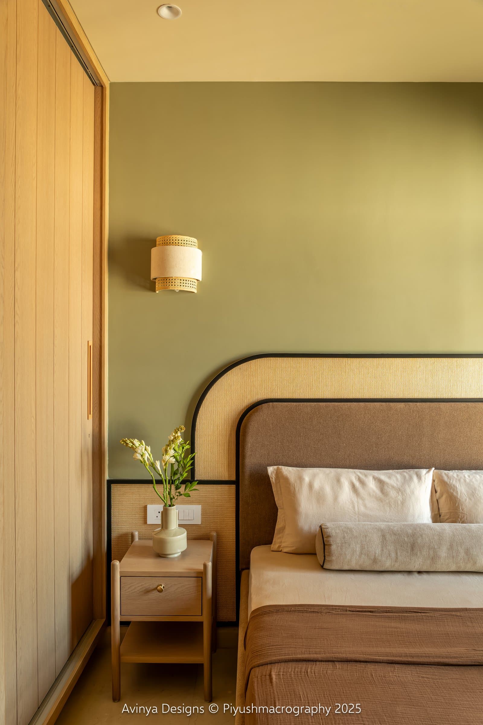 The bedside condition in the second bedroom, with a simple ash-legged nightstand and vertical slatted wardrobe beyond
